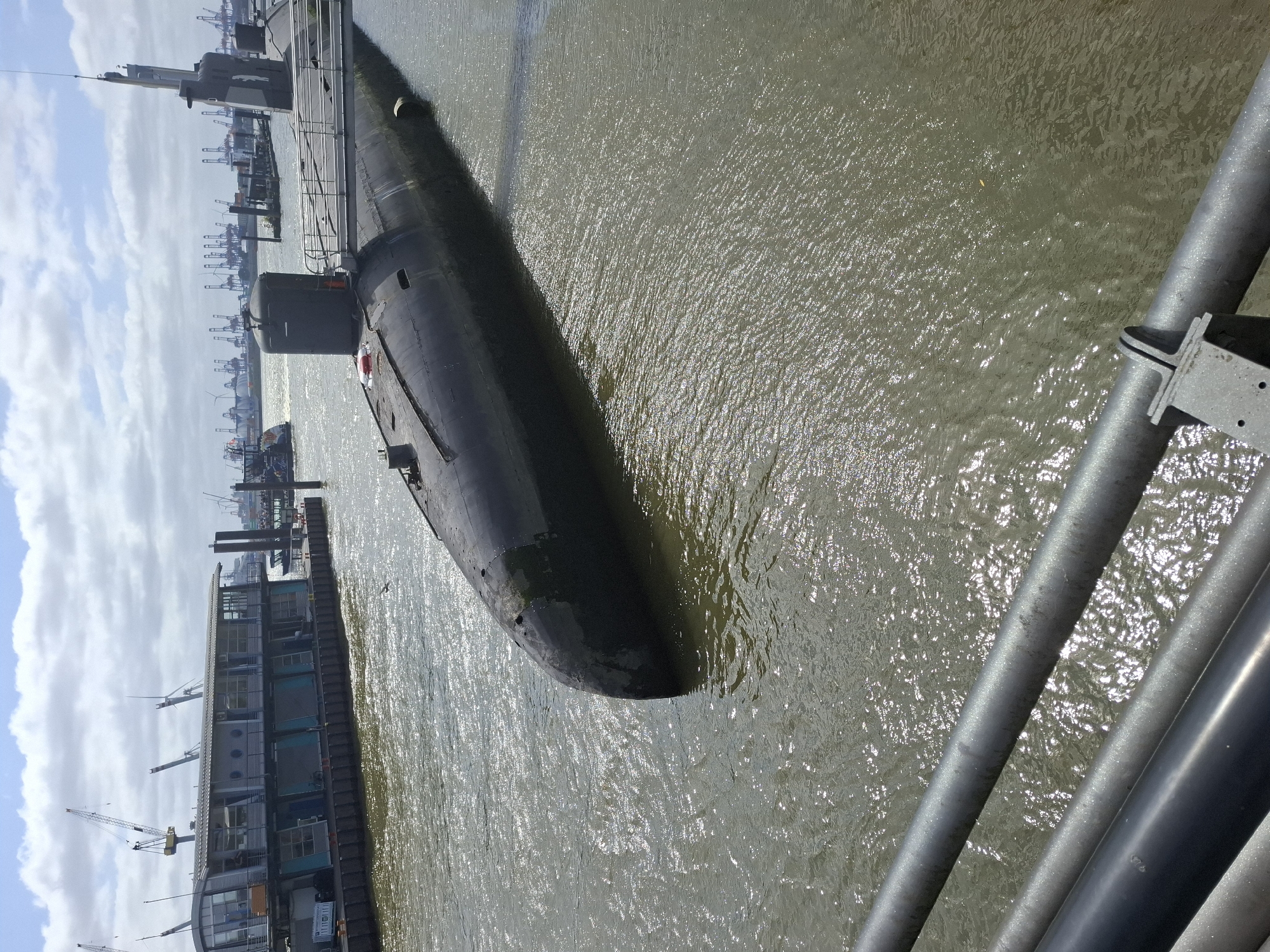 Black submarine docked at Hamburg's historic harbor district