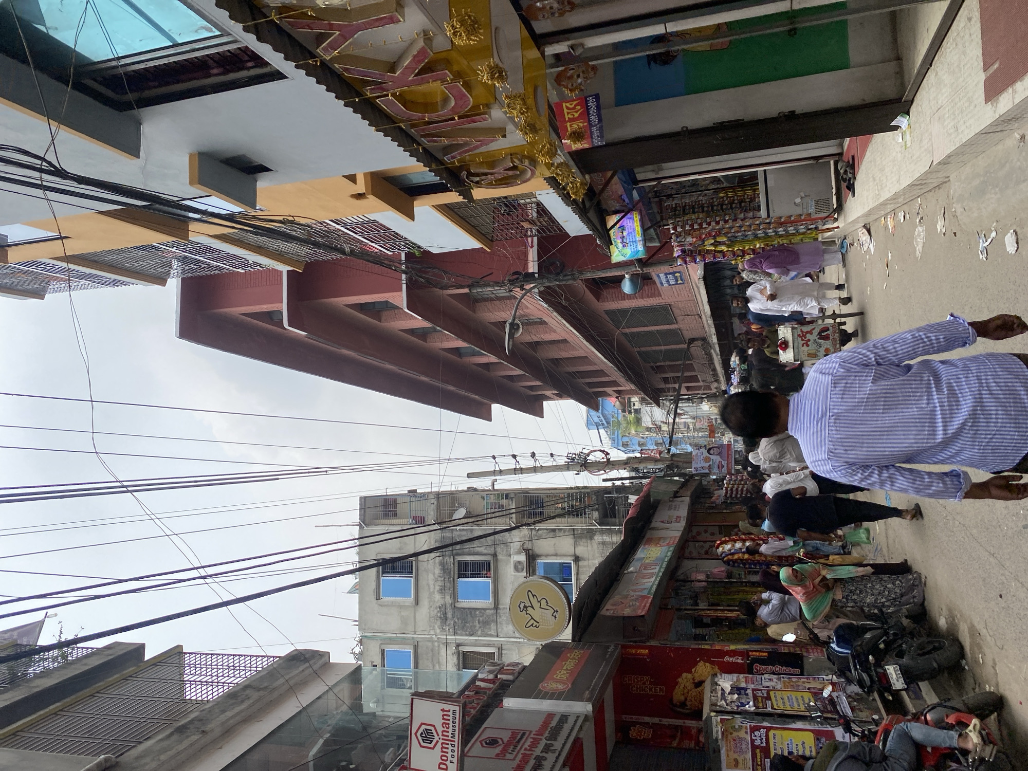 Morning street life: vendor, school children in Dhaka
