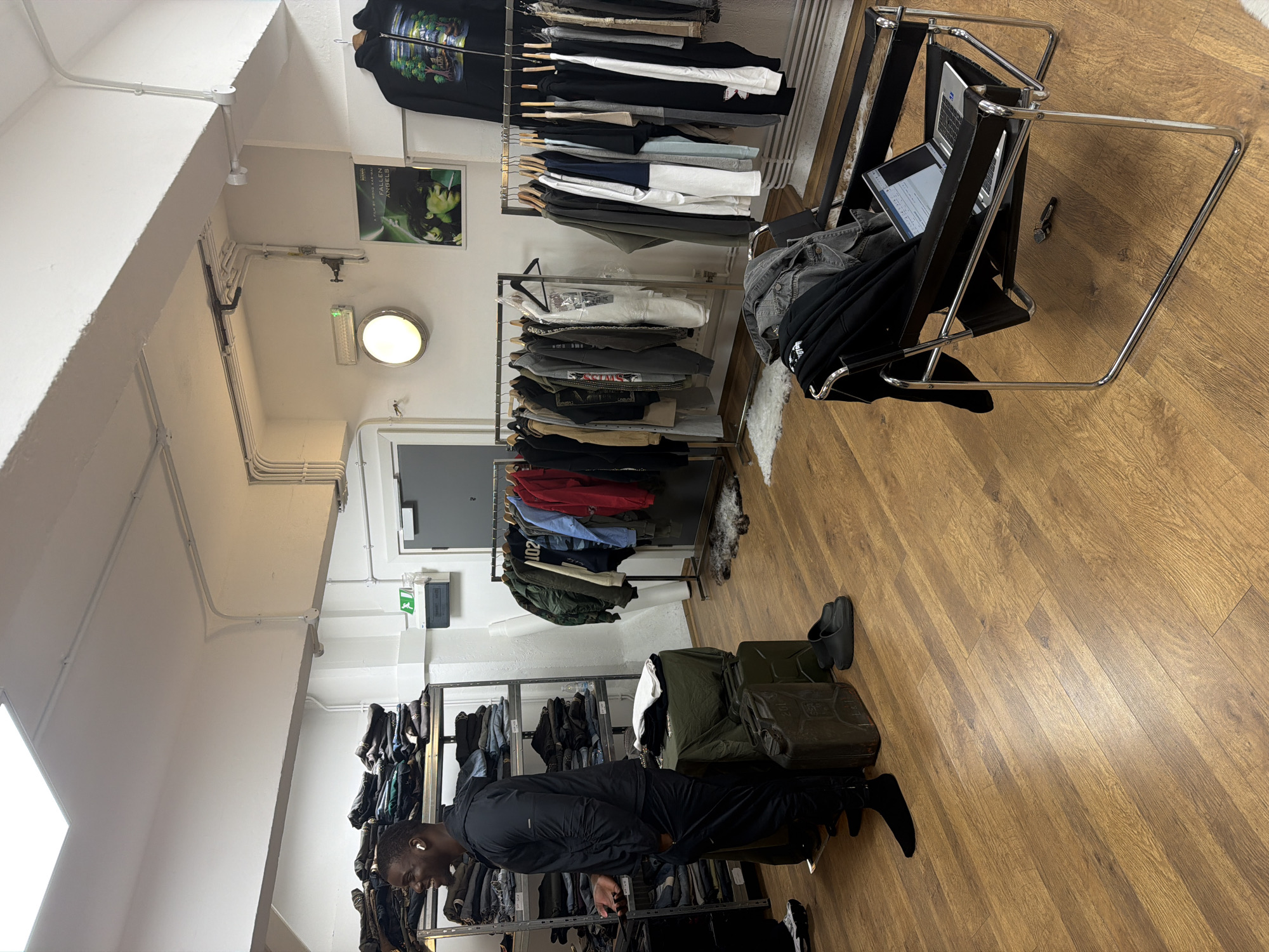 Two men browse London clothing store amid afternoon shopping