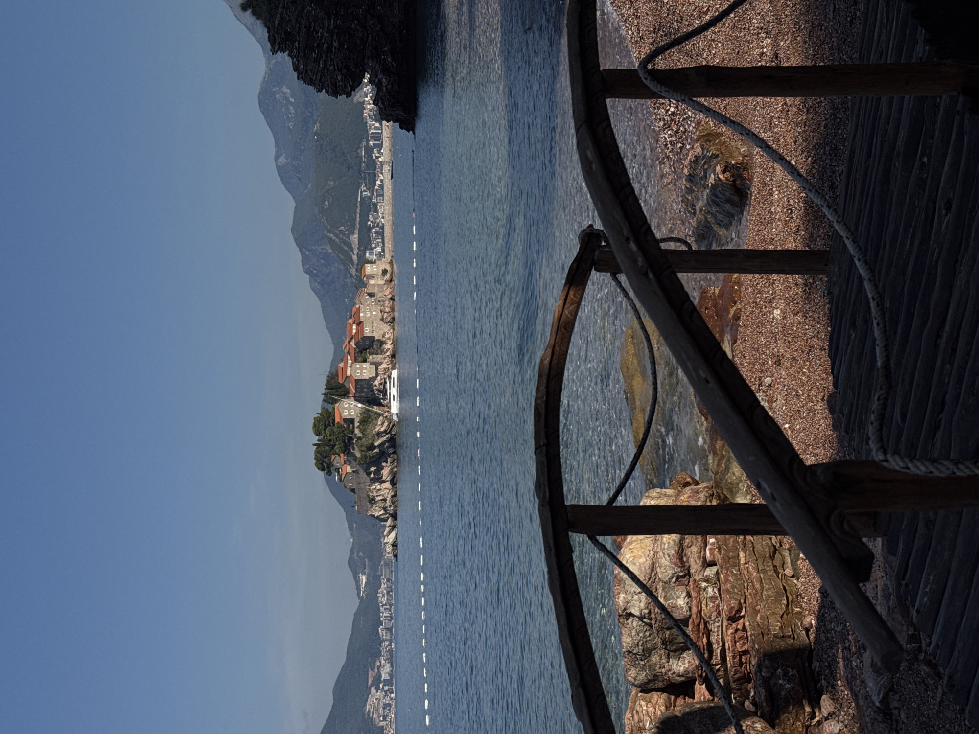 Sveti Stefan's fortified island viewed from a rustic walkway