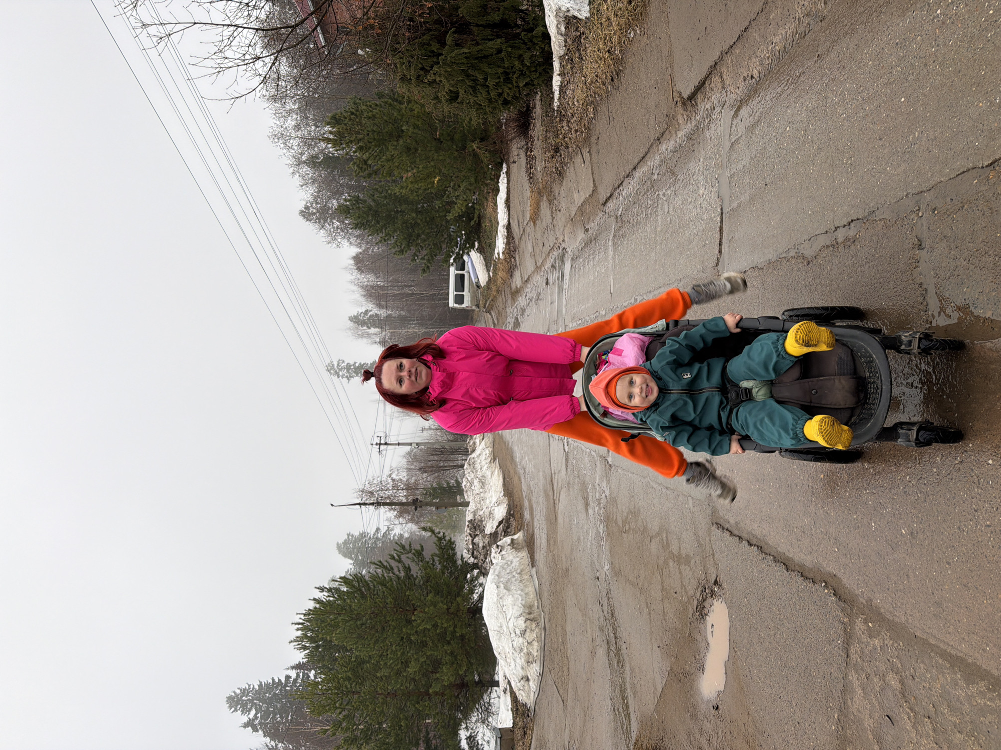 Woman rides wheeled vehicles on wet roads in Chaikovsky