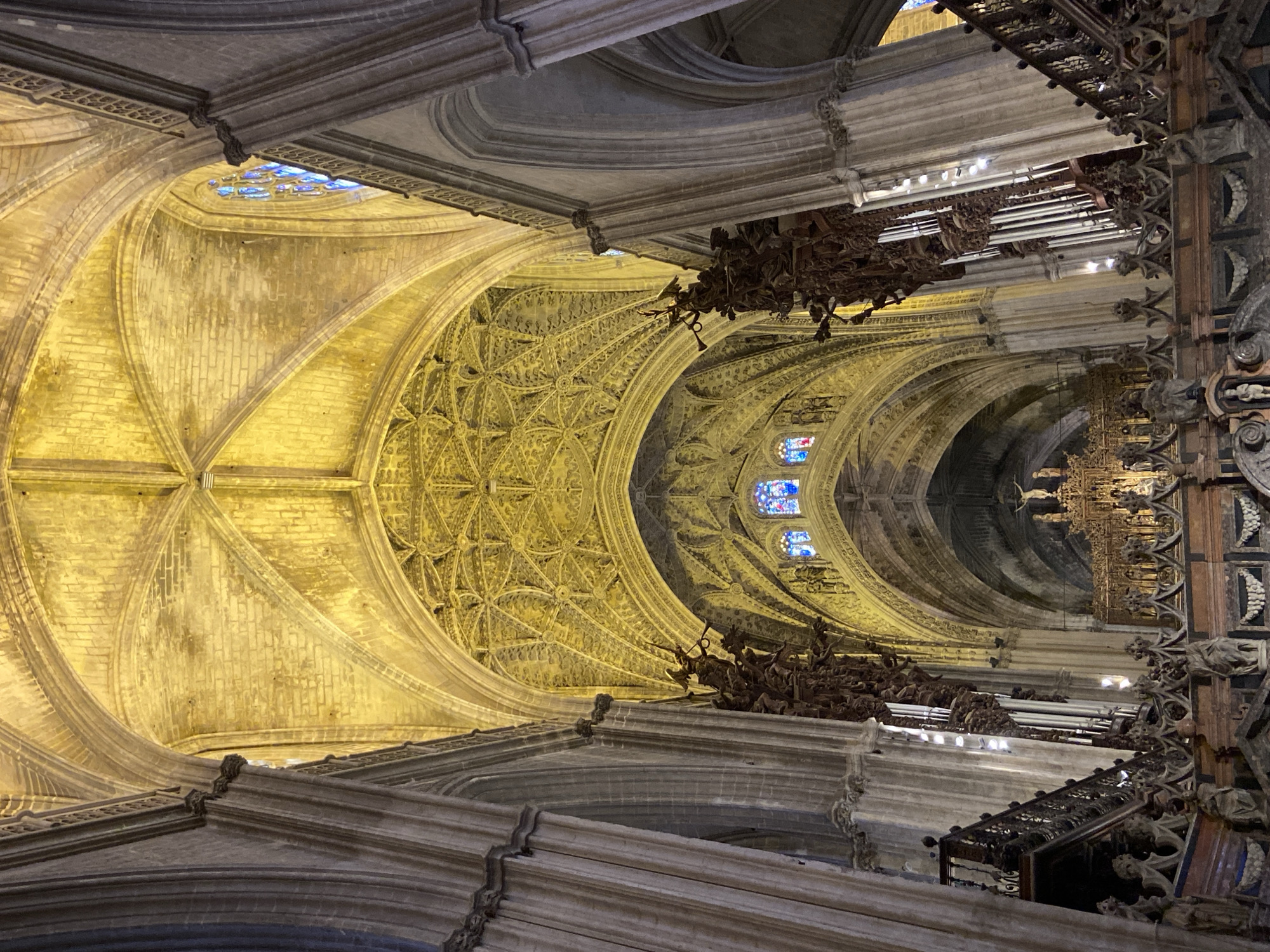 Visitor documents Seville Cathedral interior during restoration work
