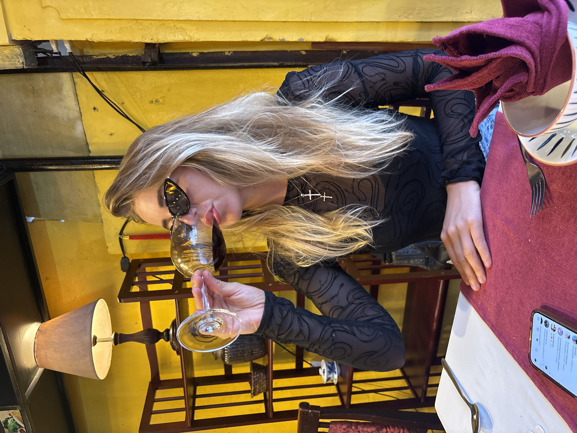 Woman dines alone at Hội An restaurant, drinks wine