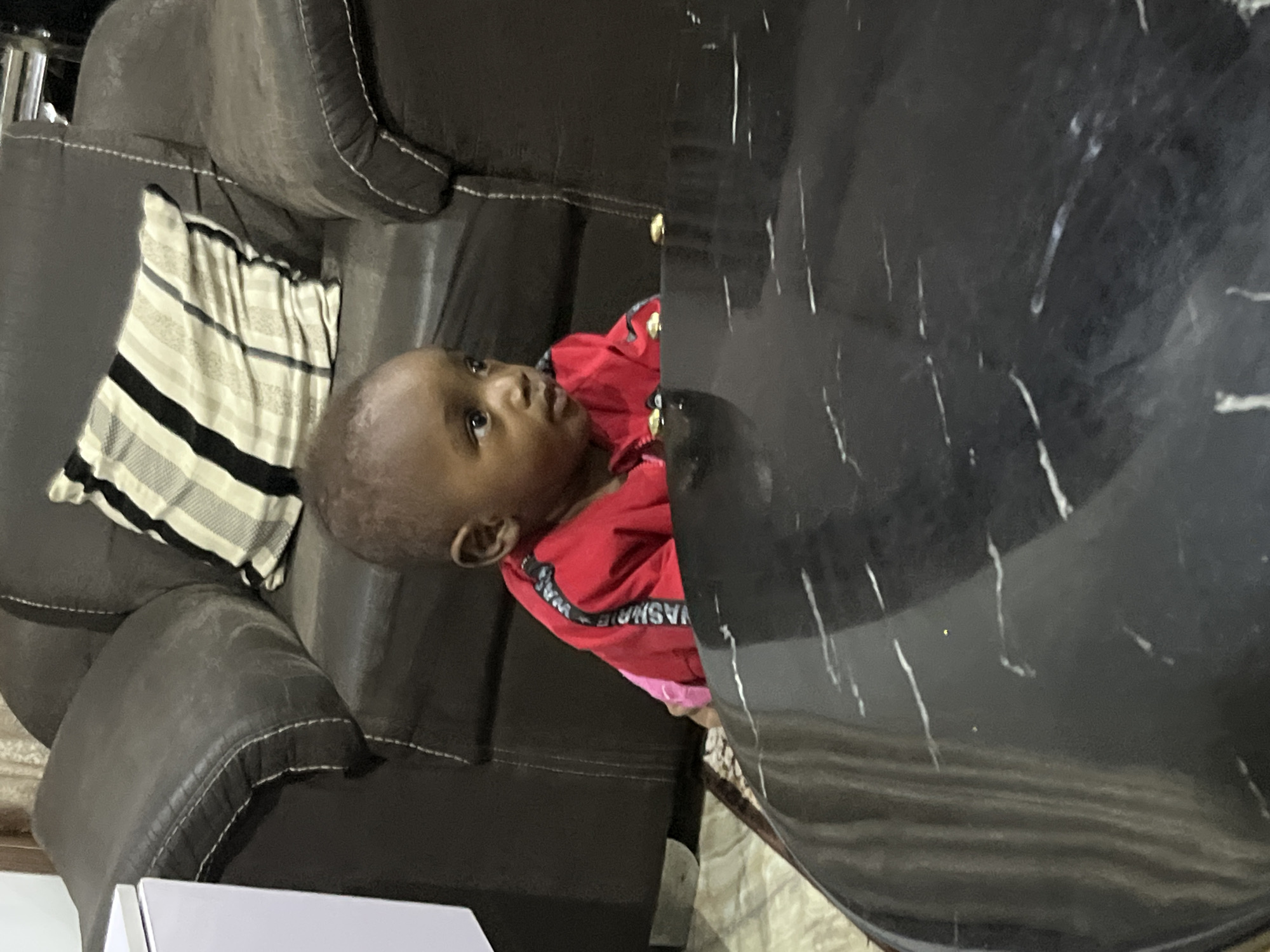 Afternoon at a Jos home: family indoors, cooking and resting