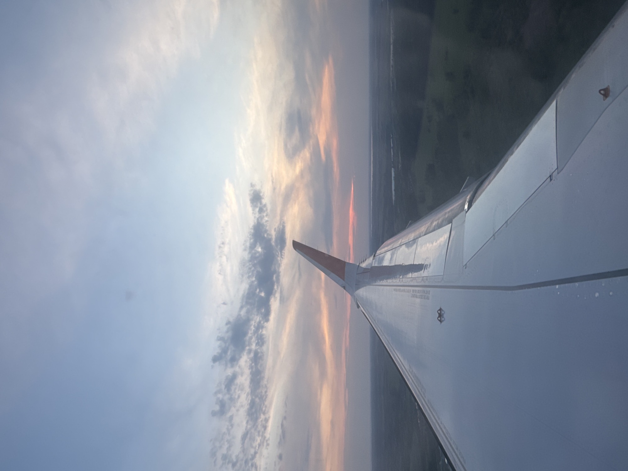 Aircraft passenger captures colorful sky view from airplane window