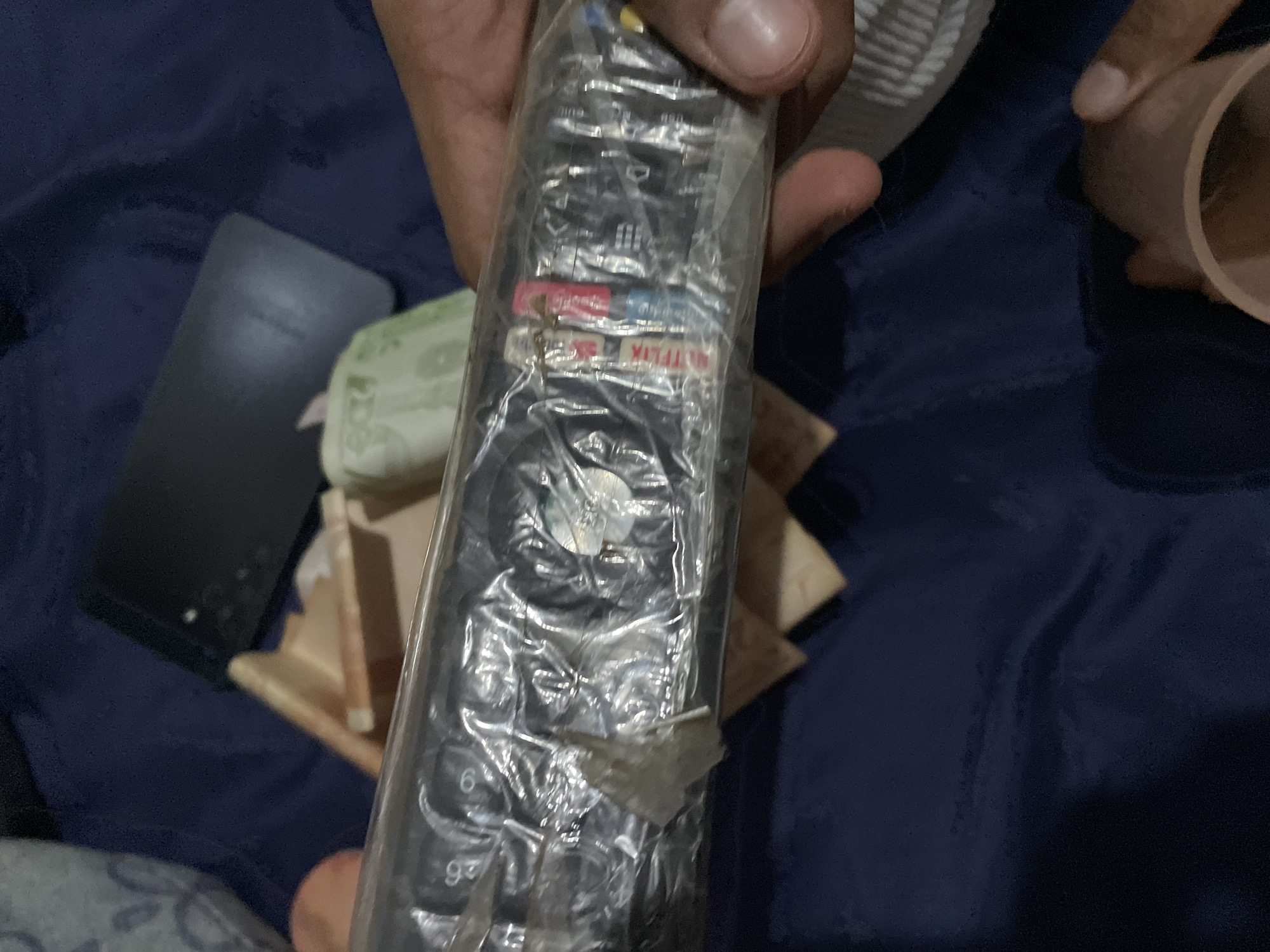 Domestic scenes with Venezuelan currency and electronics documented indoors