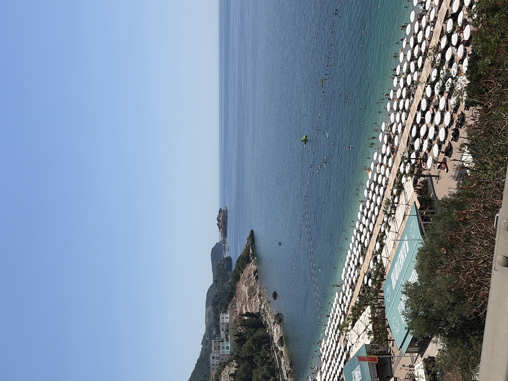 Busy summer morning at Kamenovo beach and Trap village, Montenegro