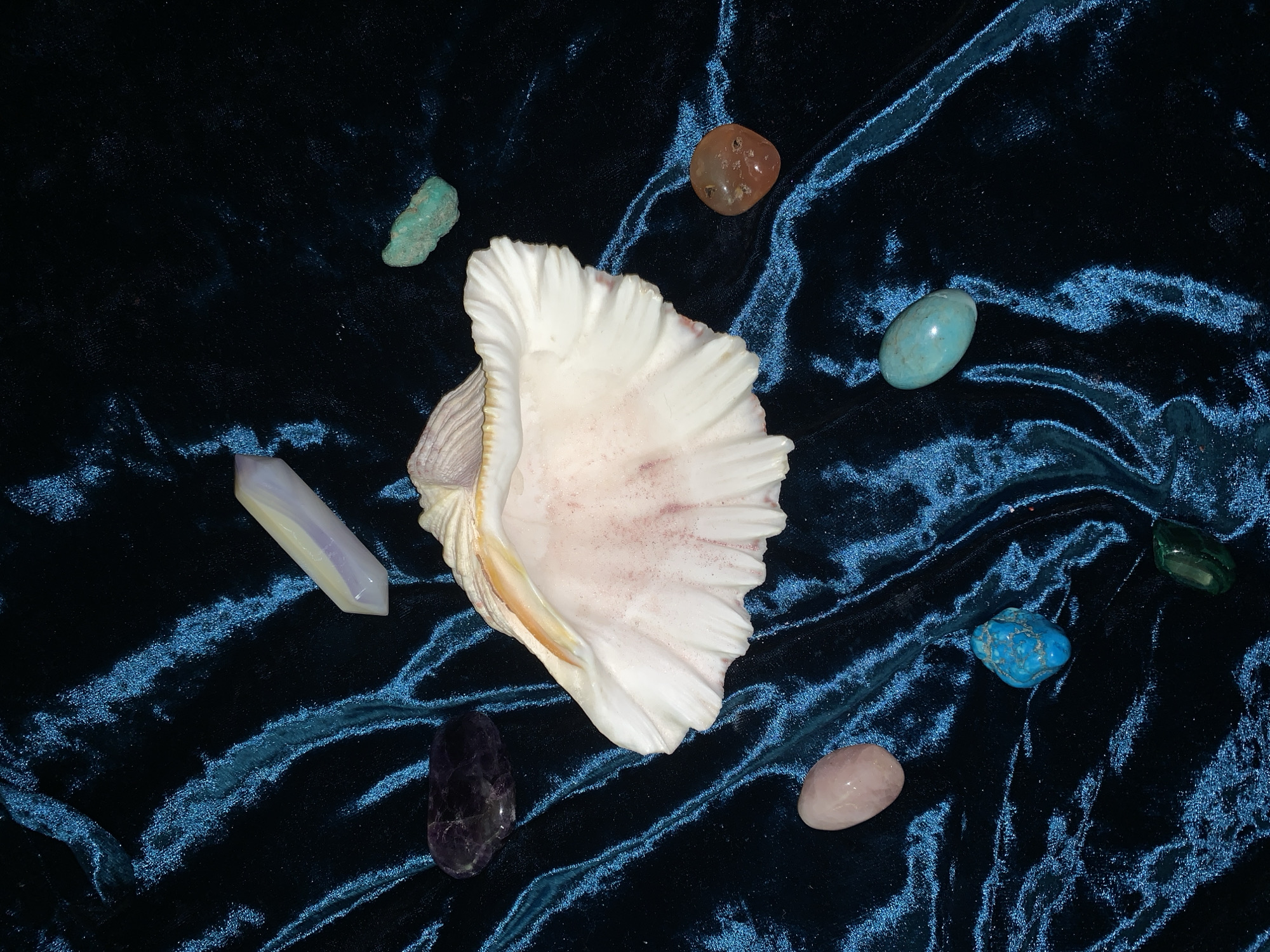 Tarot cards, crystals, sketchbooks, and portrait shots on velvet