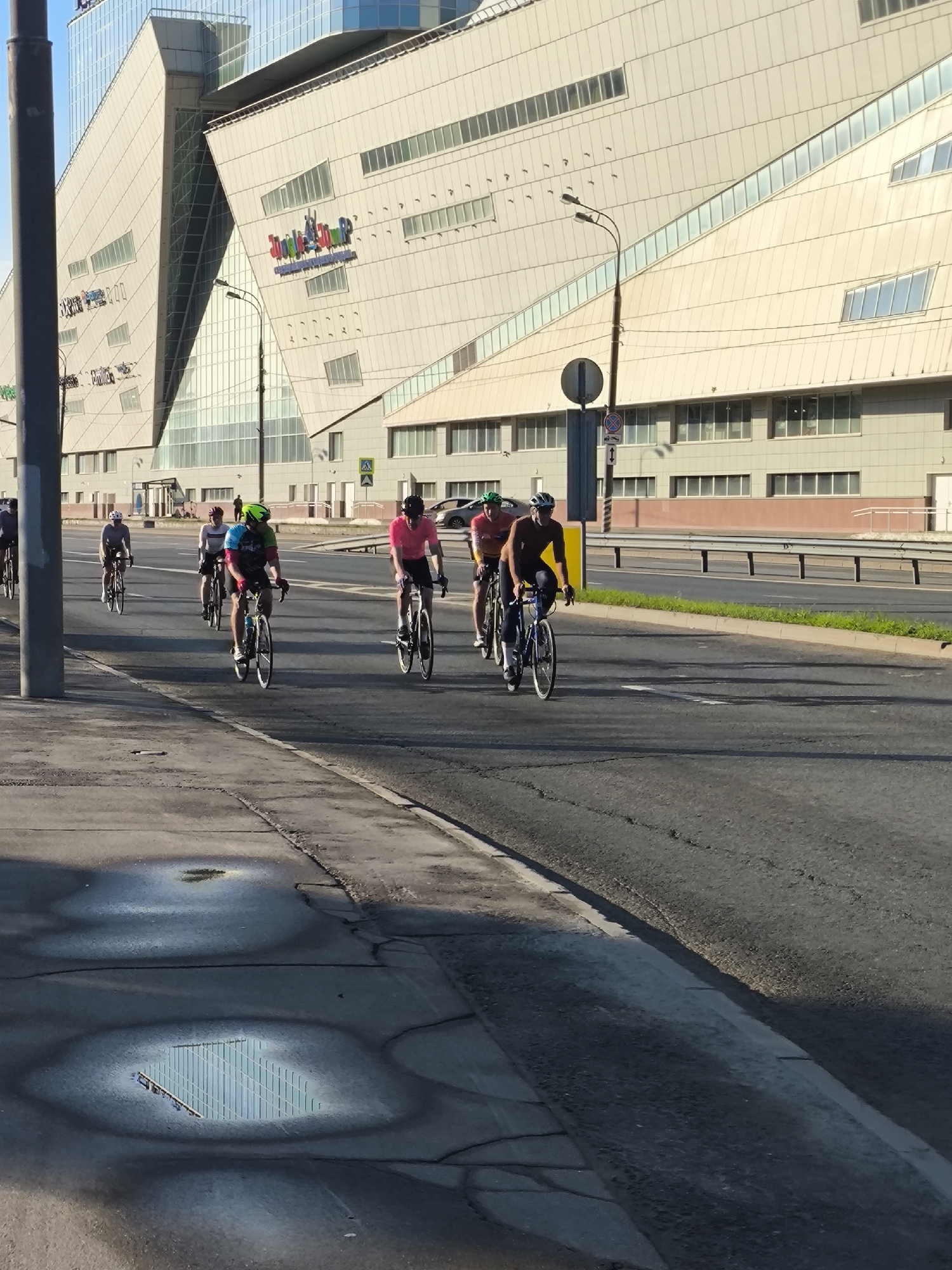 Cyclists ride through urban area in early morning hours