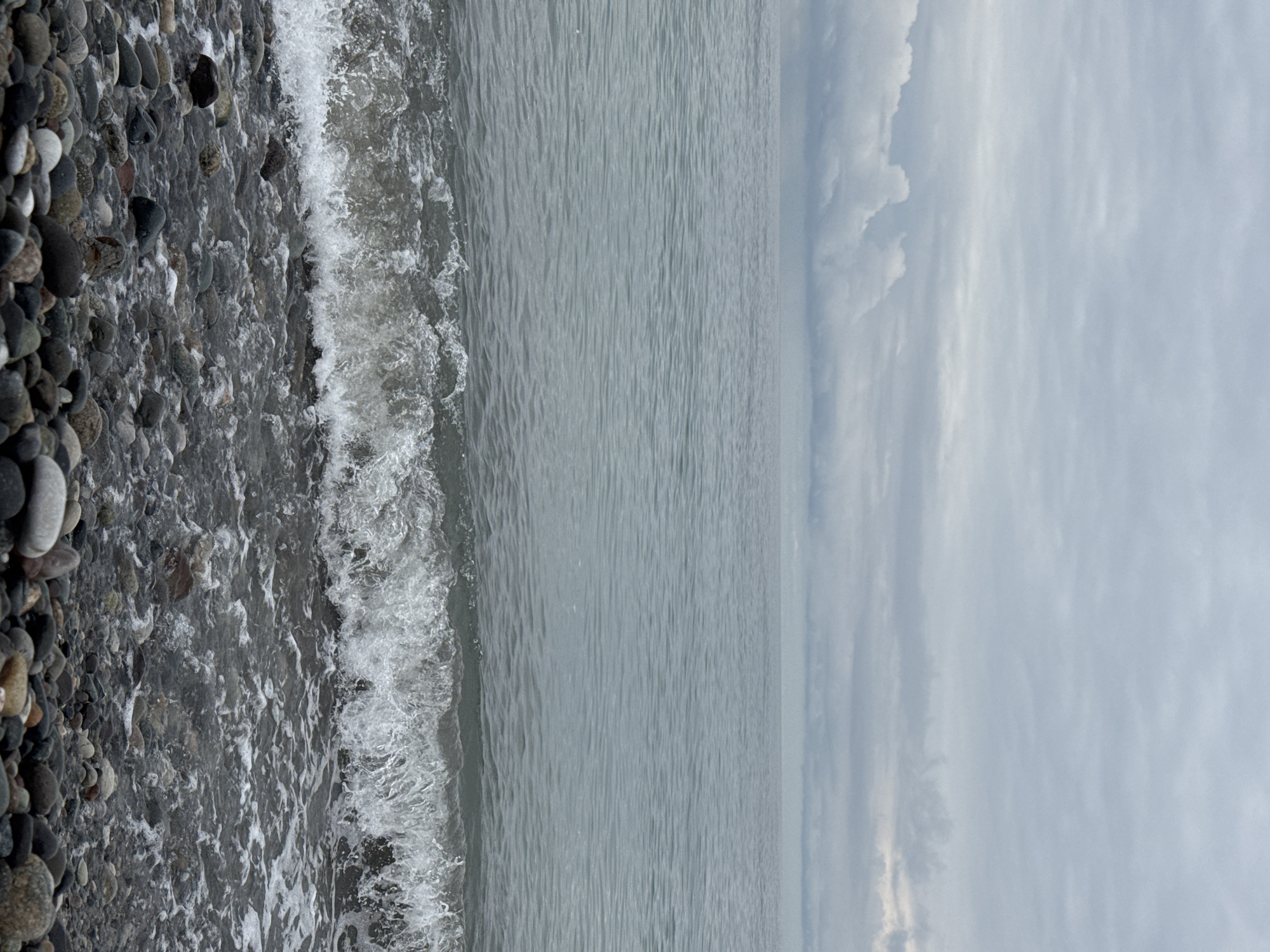 Batumi's pebble beach and promenade on a grey morning