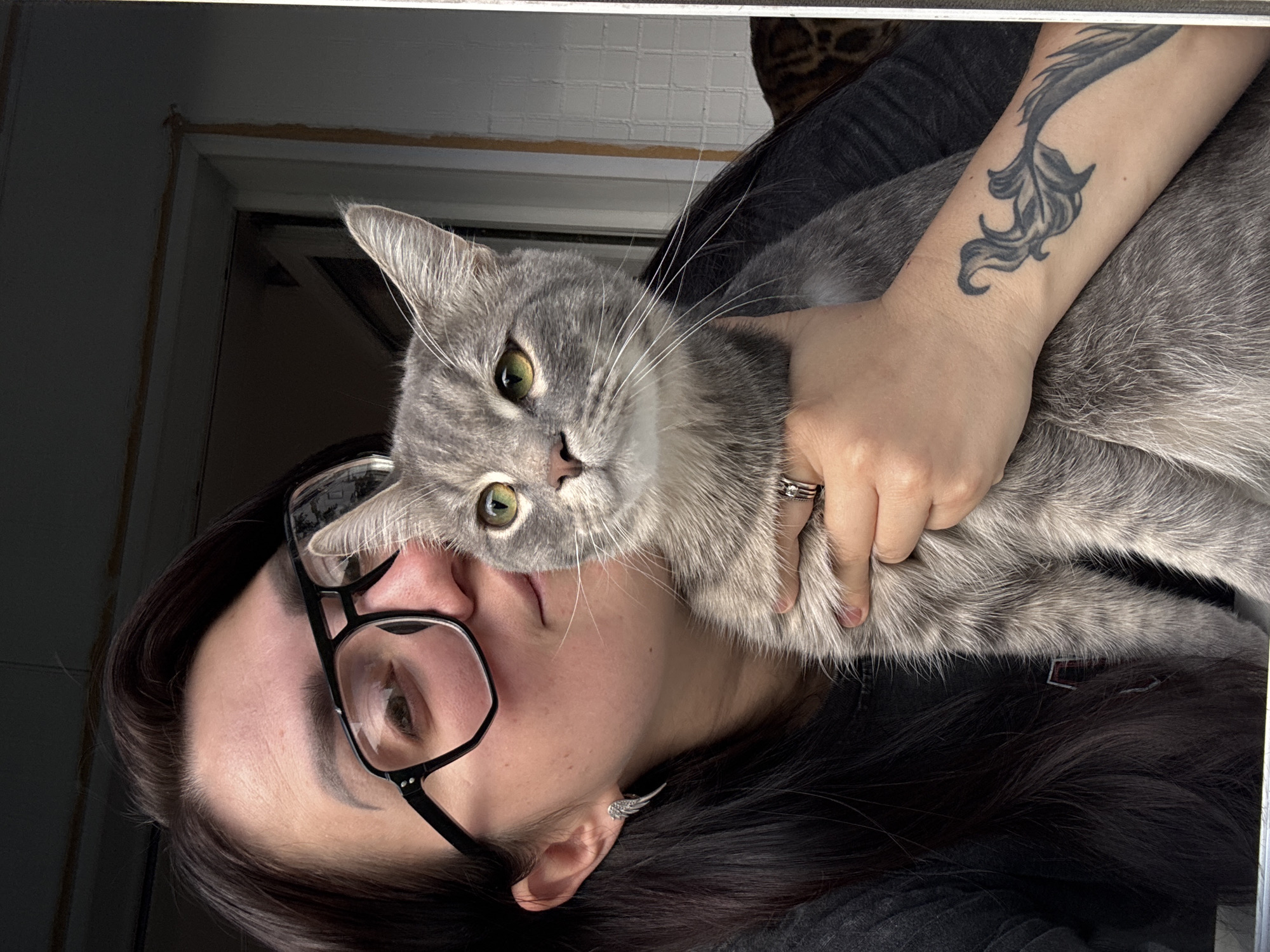 Pet owner photographed with cats and rats indoors