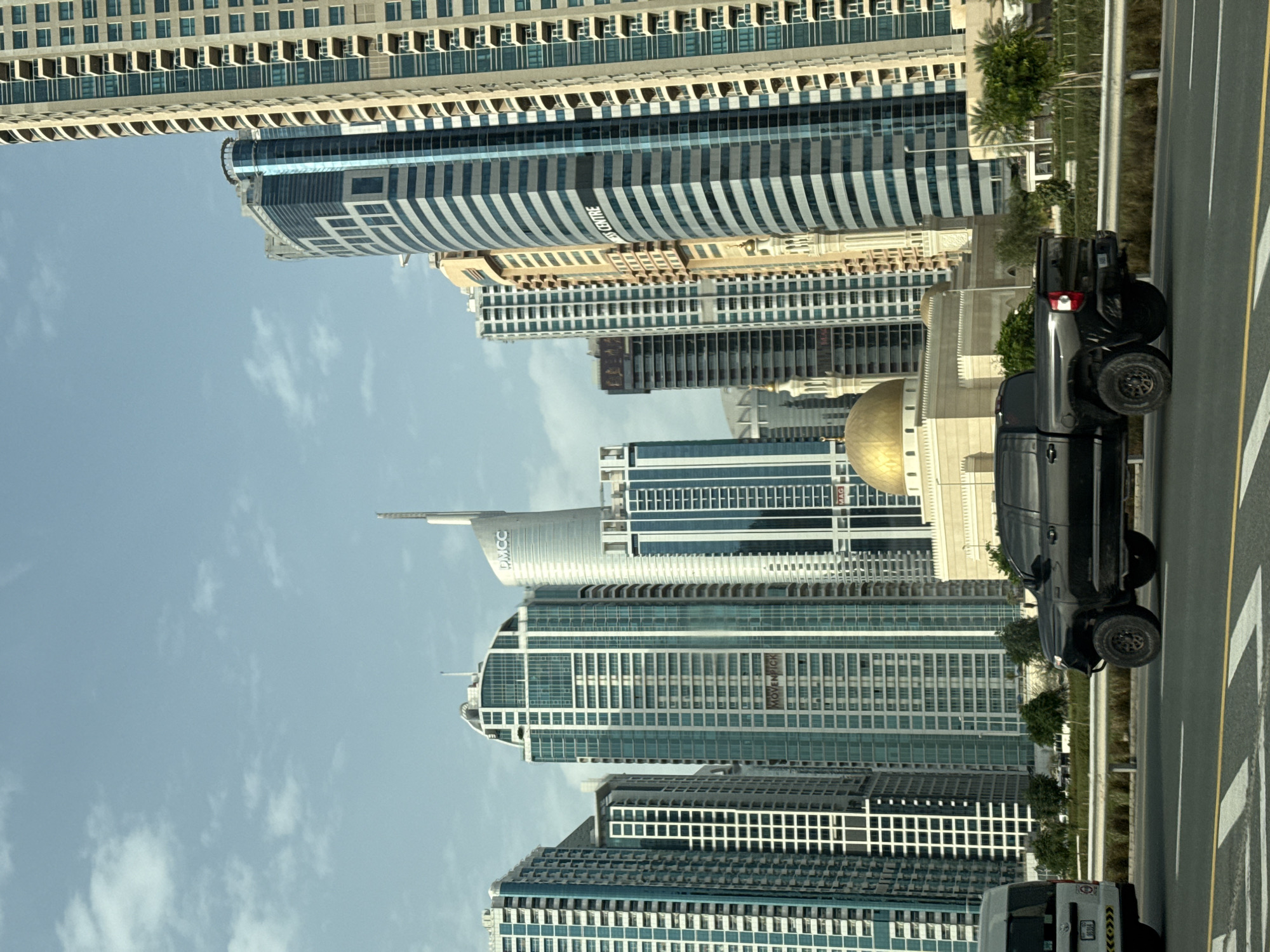 Dubai skyline observed under partly cloudy afternoon skies