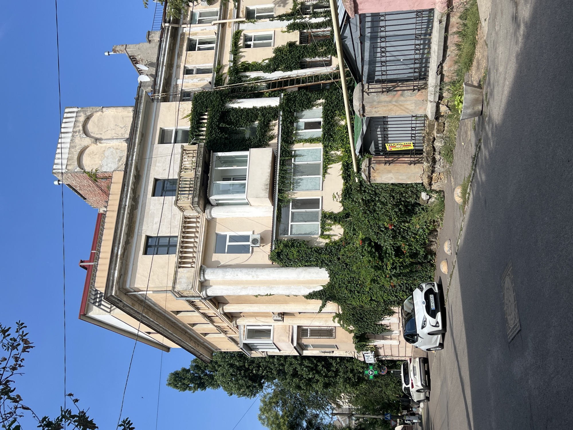 Weathered cream building on a sunny Odesa street
