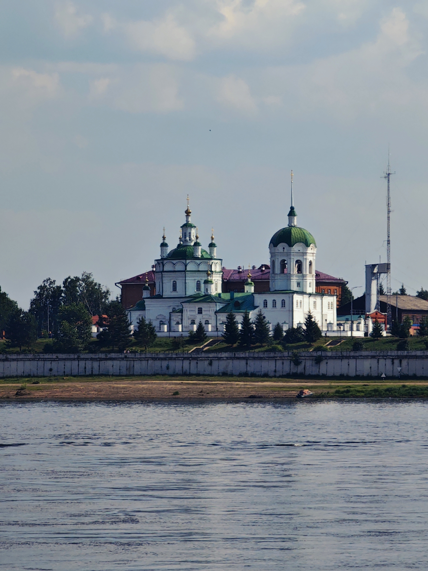 Yeniseysk riverfront and its historic church skyline from the water
