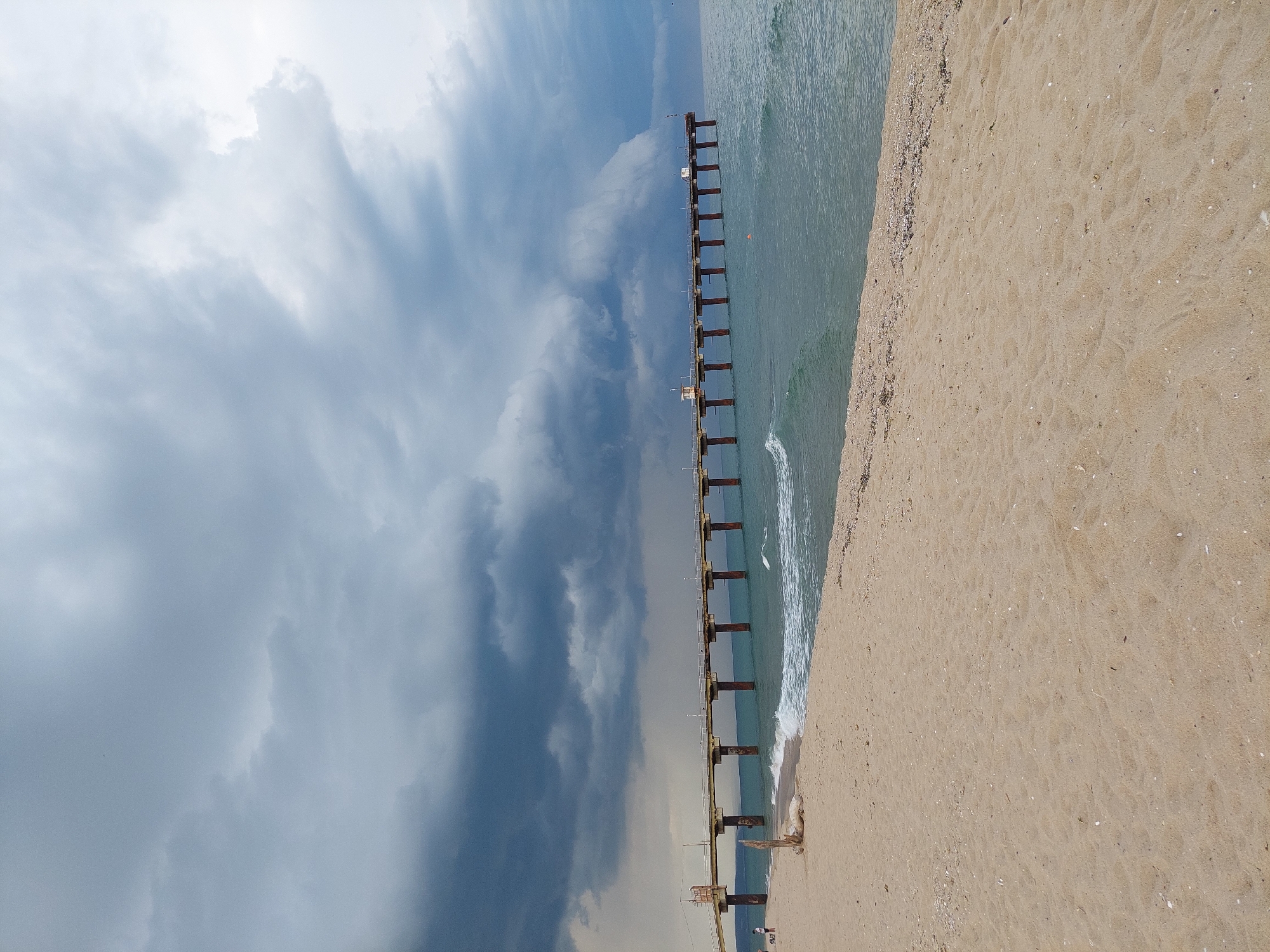 Shkorpilovtsi beach and Black Sea pier under stormy skies