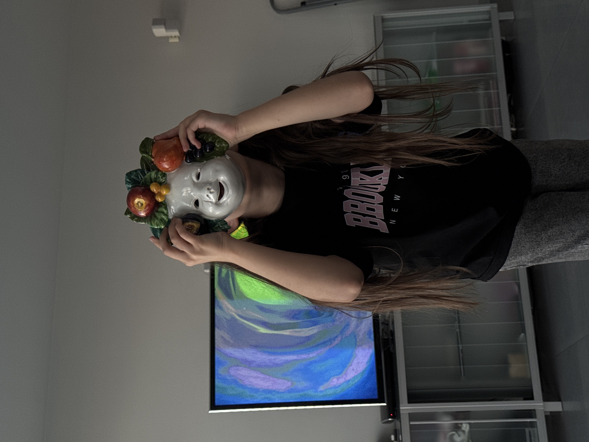 People gather with cats, fruit mask in living room