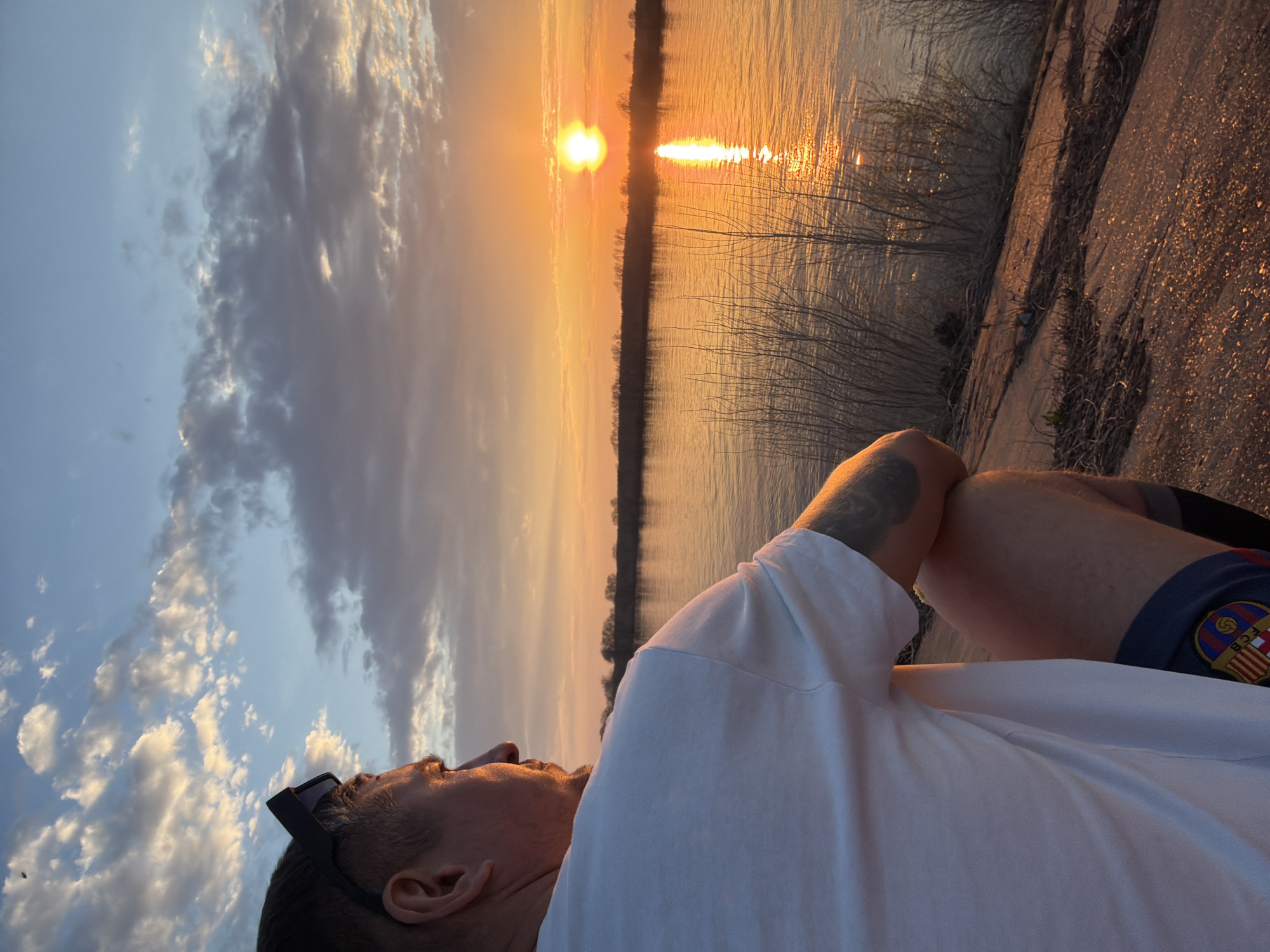 Person enjoys sunset moment by Kama River in Chaikovsky