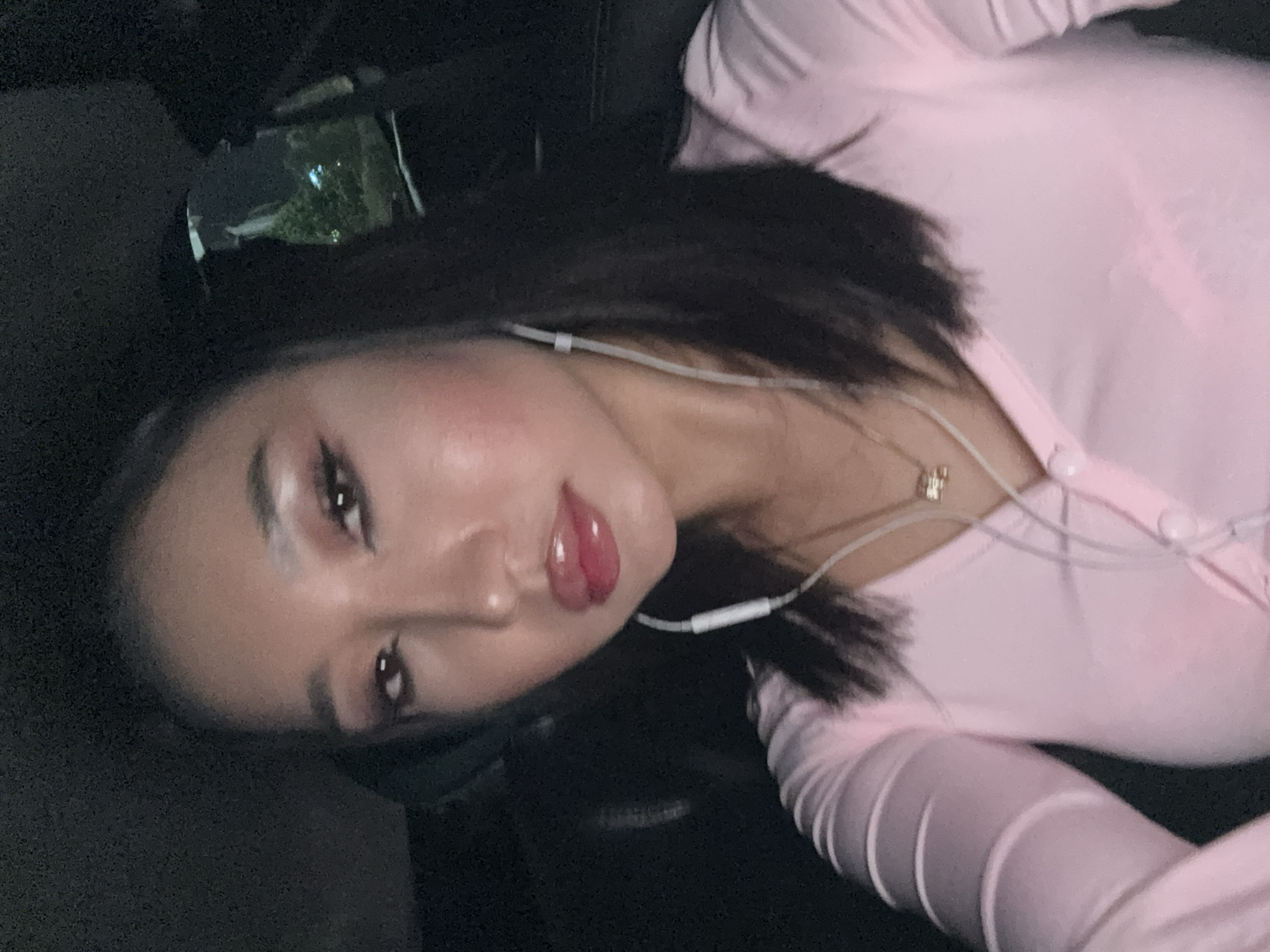 Woman photographed in pink outfit during vehicle travel in Kuta