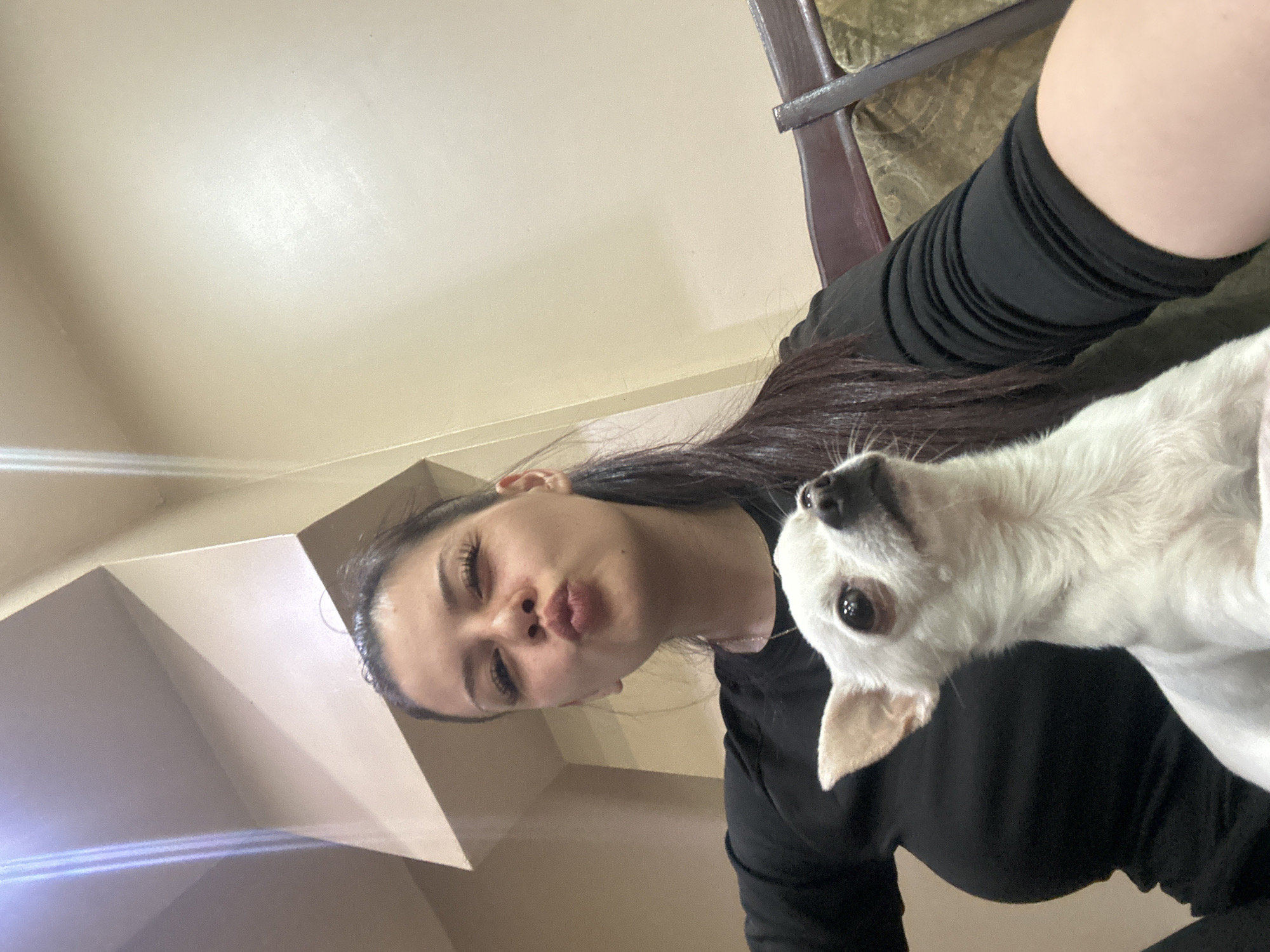 Woman takes selfies with small white dog in Sliven