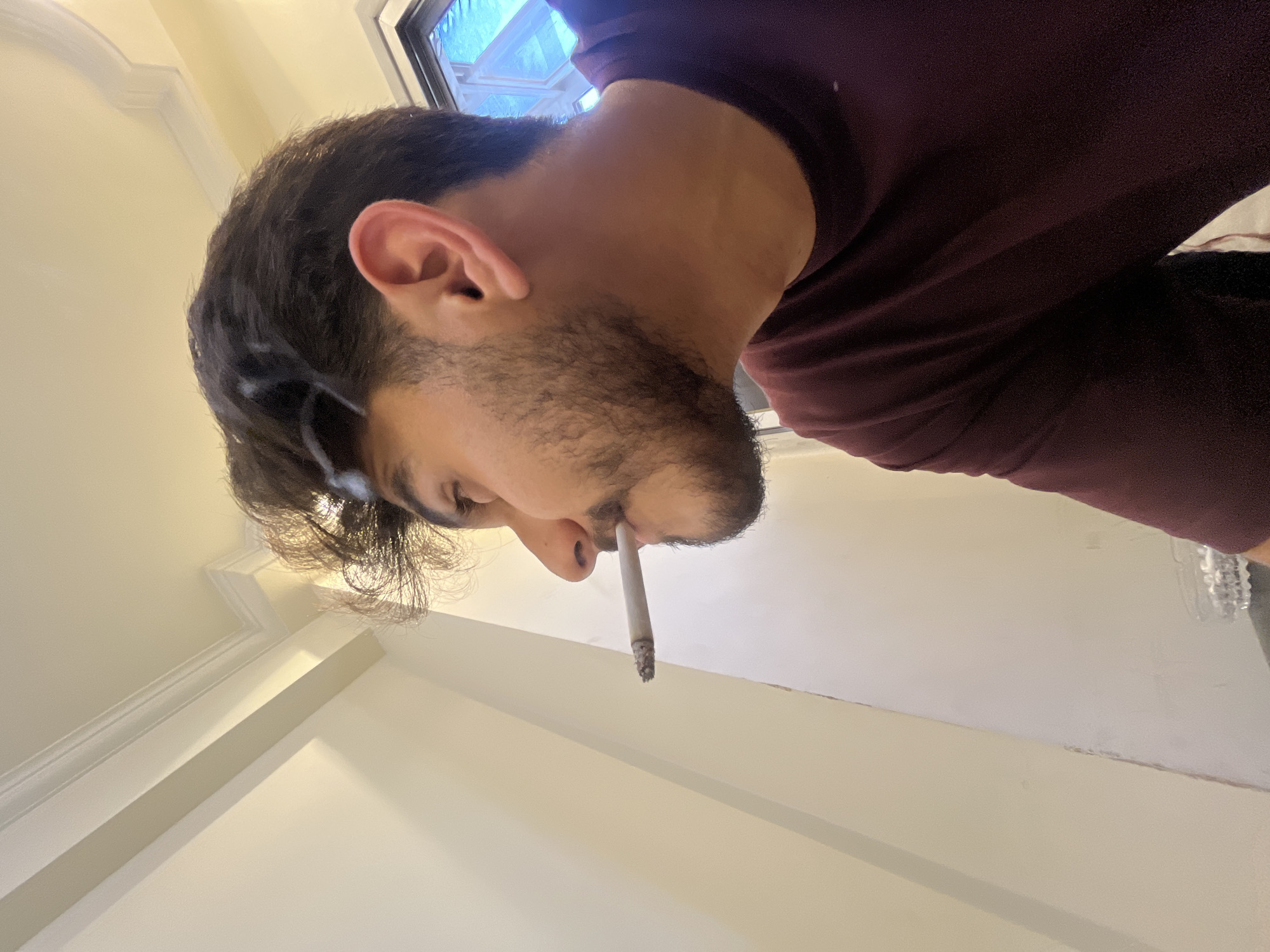 Man spends afternoon smoking and relaxing indoors in Damascus