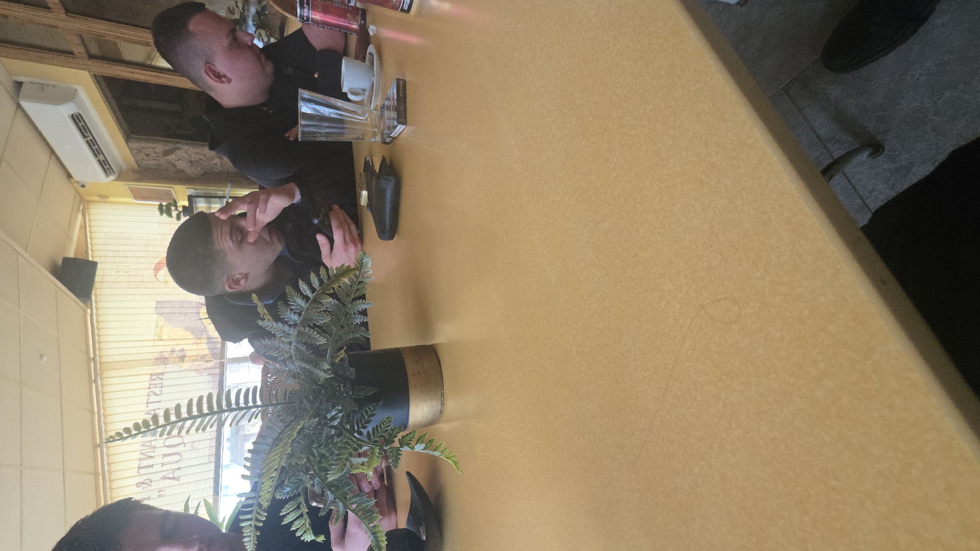 Two men dine at restaurant table in Balgarevo