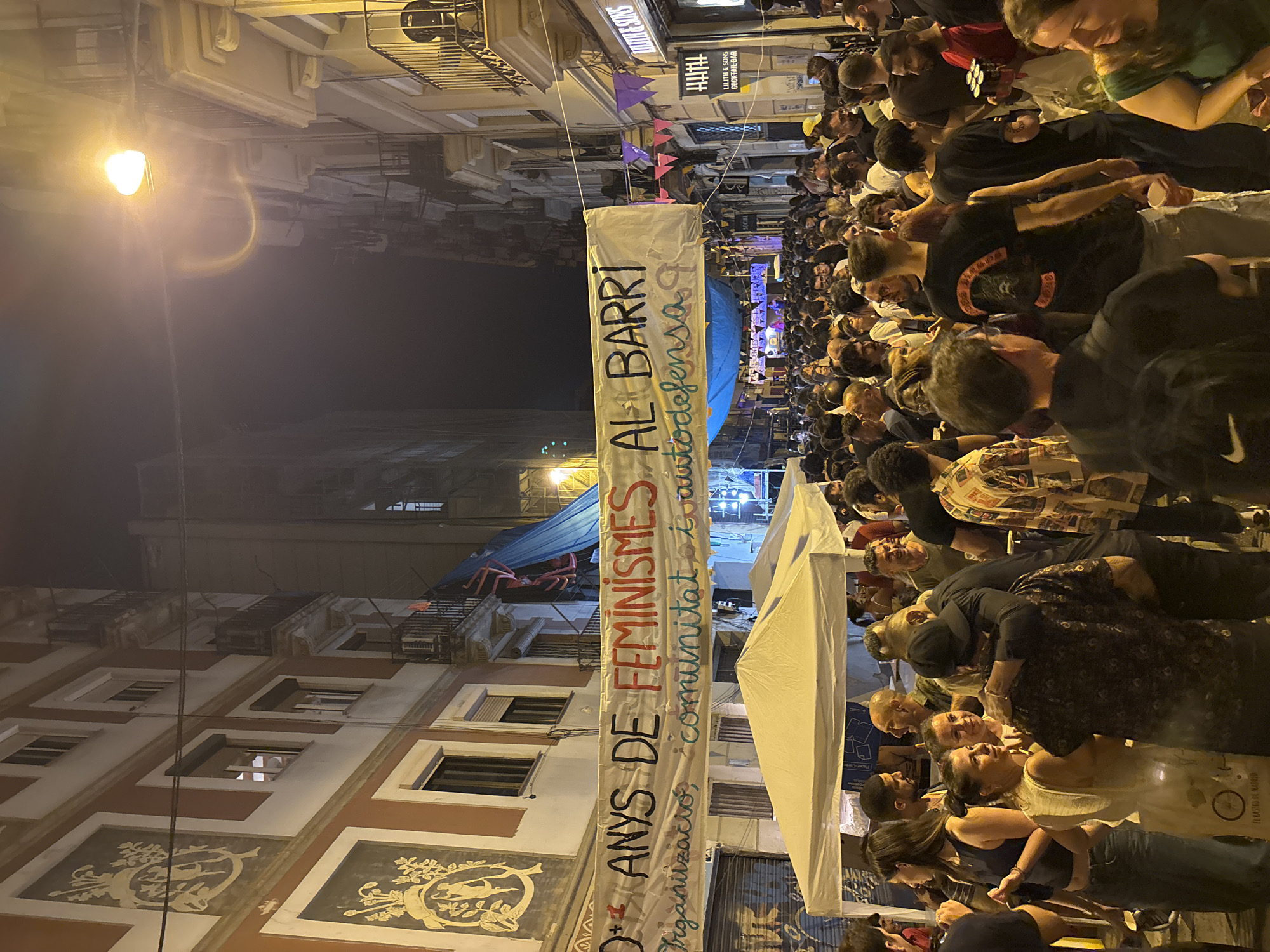 Barcelona neighborhood feminist festival fills the streets at night