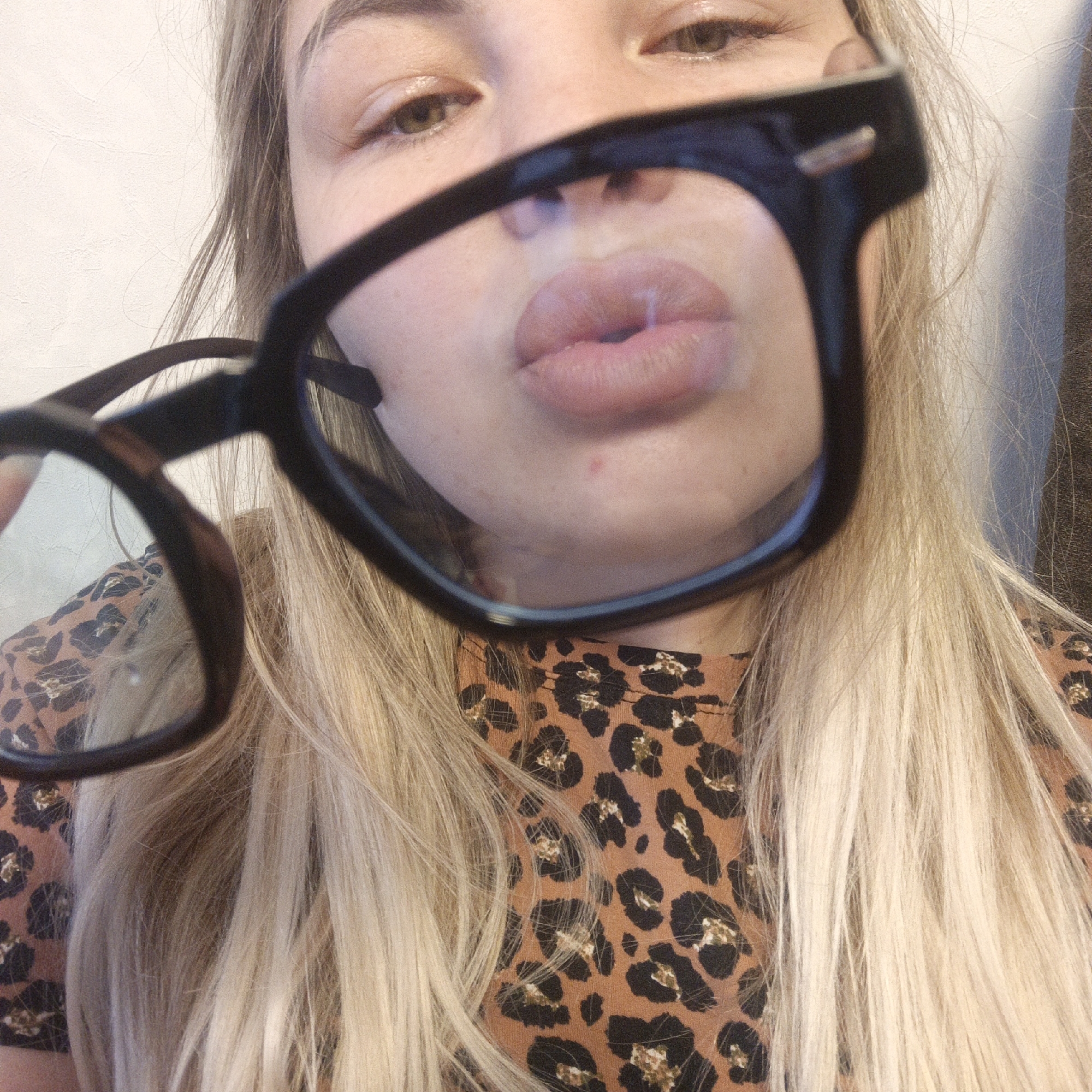 Woman in glasses photographed repeatedly, cat and toy play captured