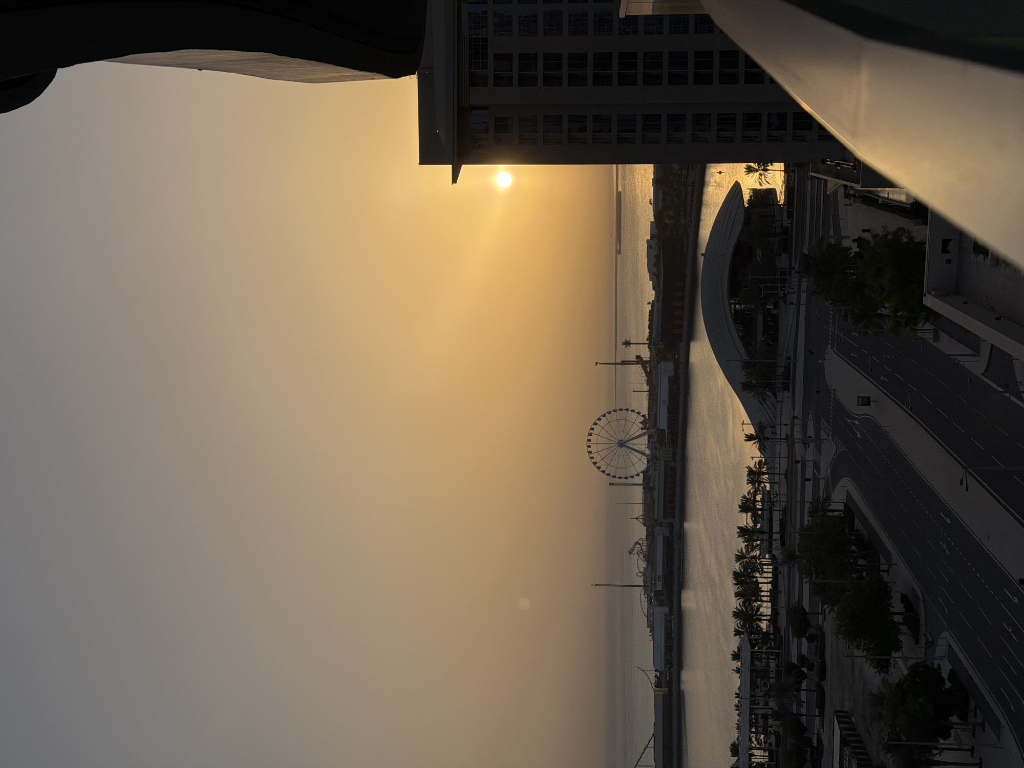 Golden hour over Lusail's waterfront, coffee in hand