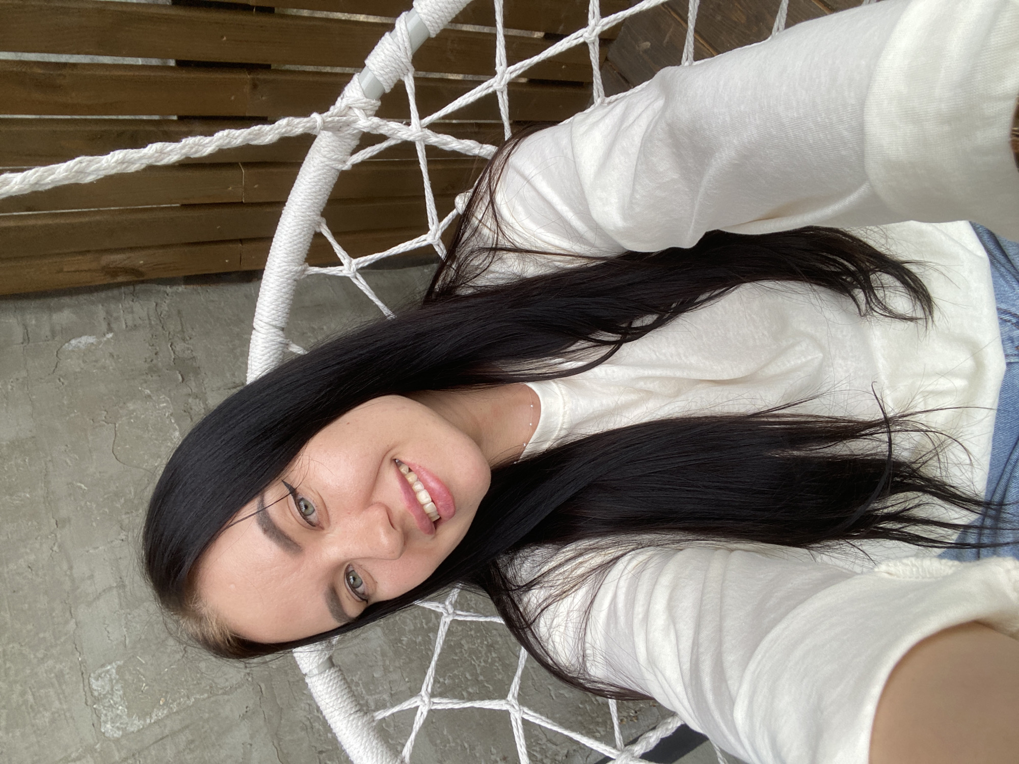 Woman takes selfie in hammock chair in Foki, Russia
