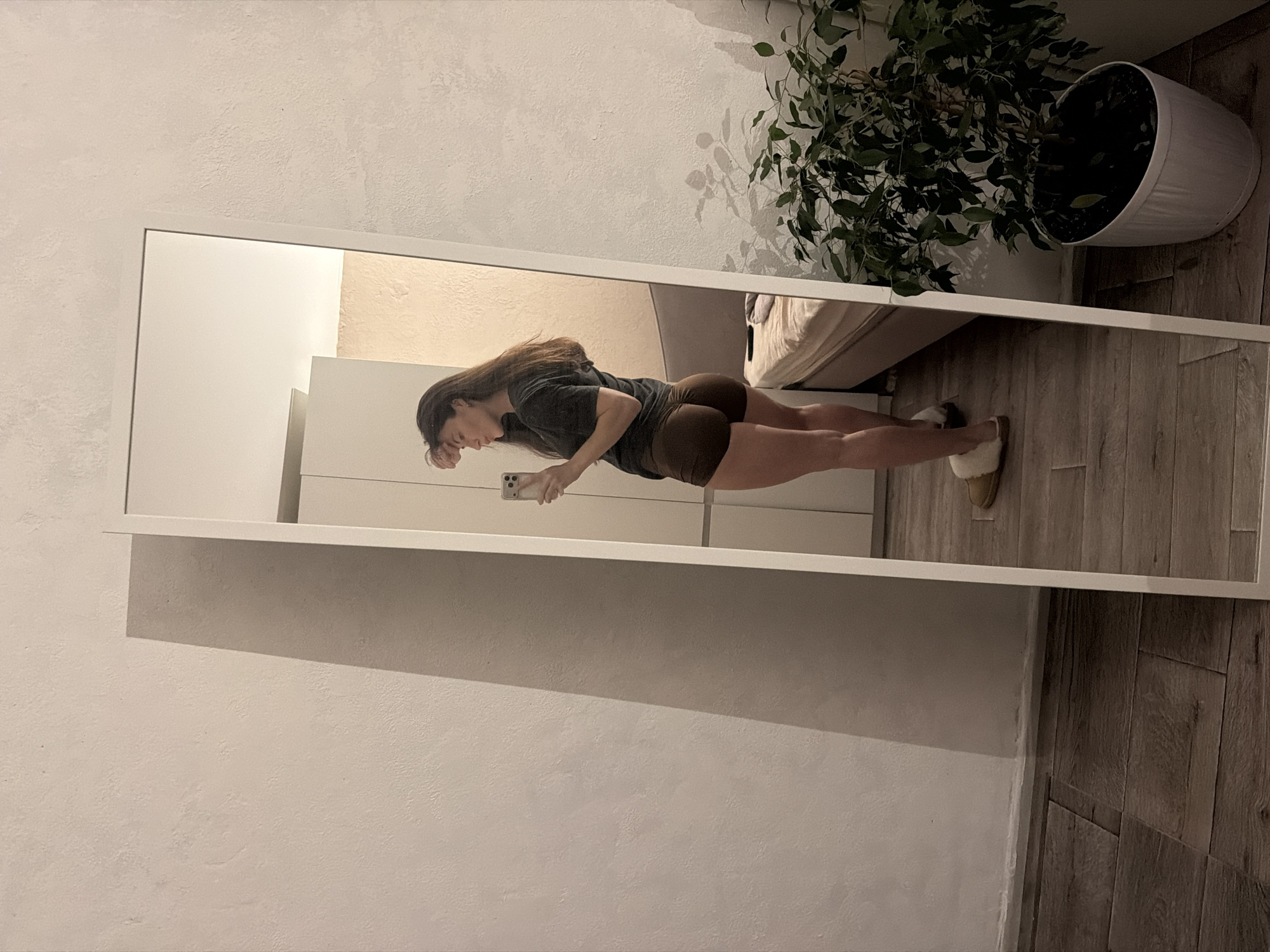 Woman takes mirror selfies in Perm bedroom