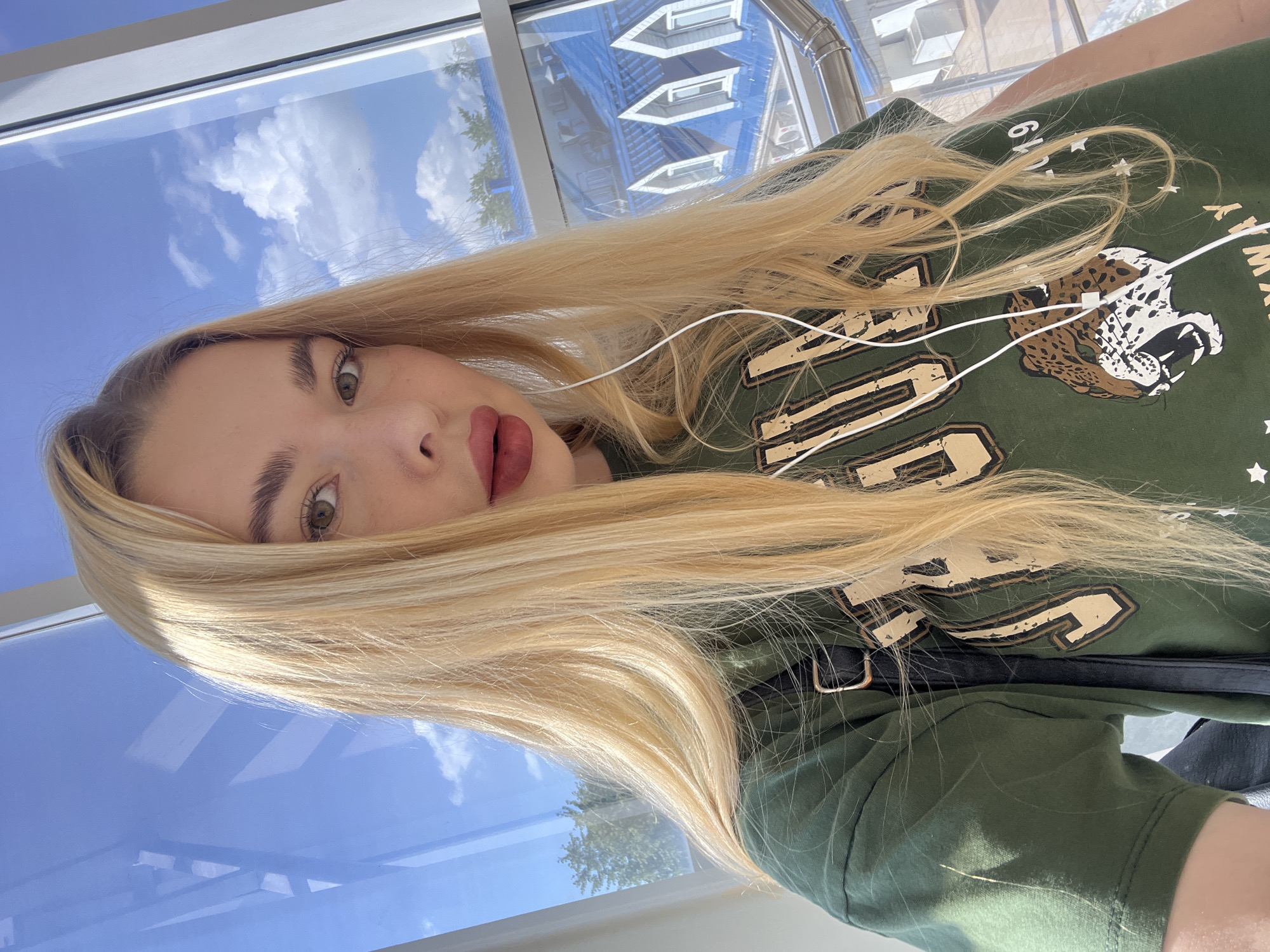 Selfie session across a Krasnodar interior, green tee throughout