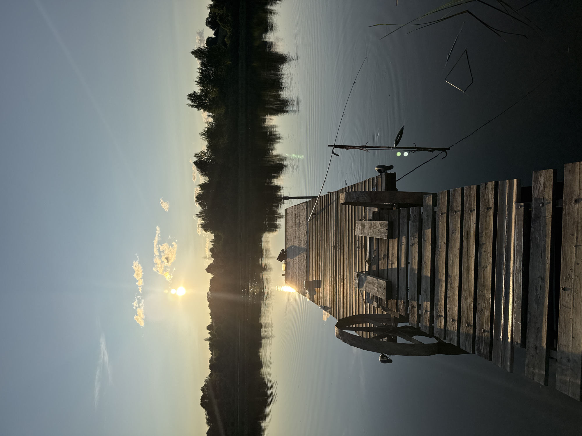Sunset fishing and boating on a quiet lake in Sitno