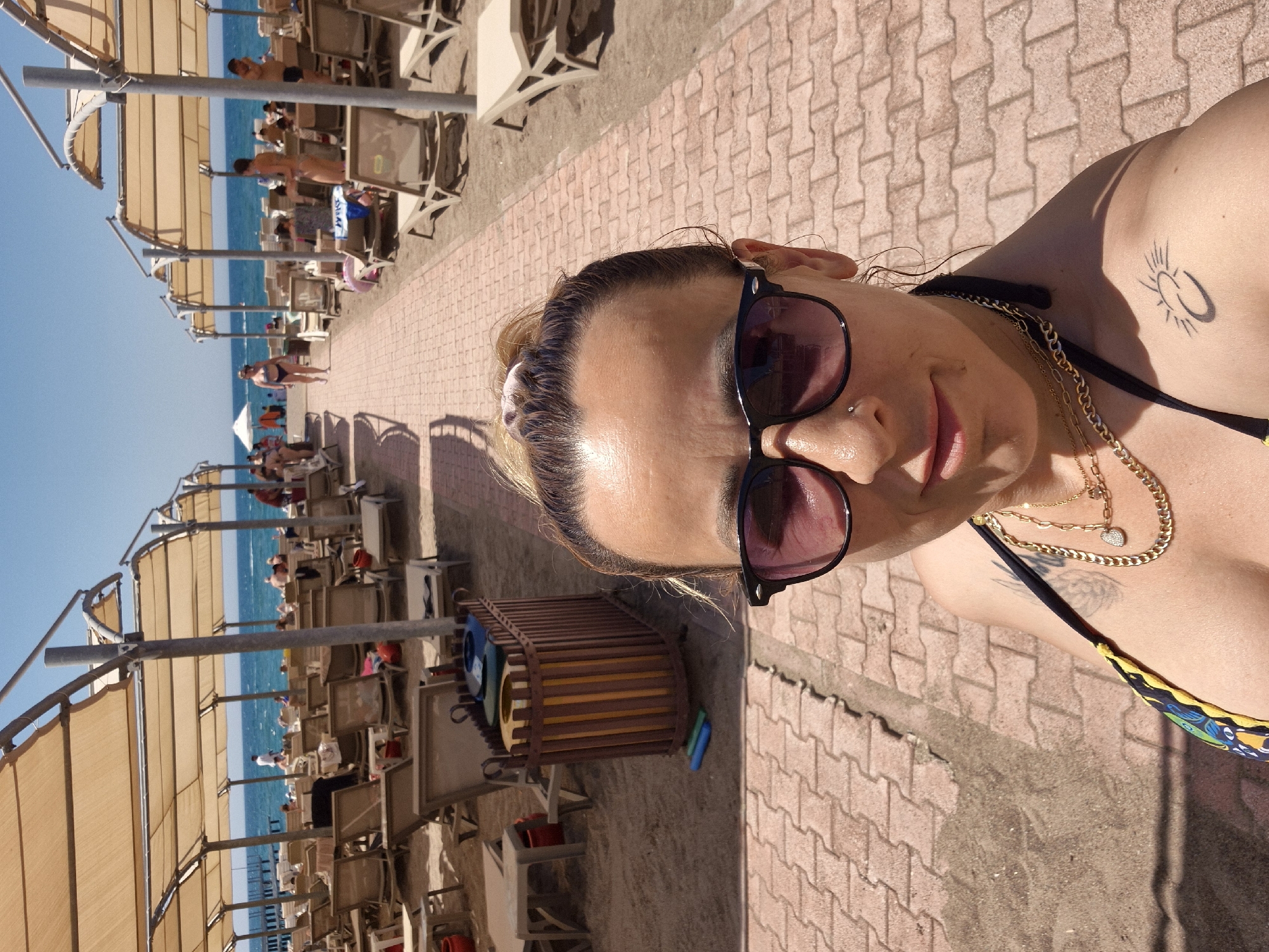 Sunny beach resort day with selfies, flora, and crowds