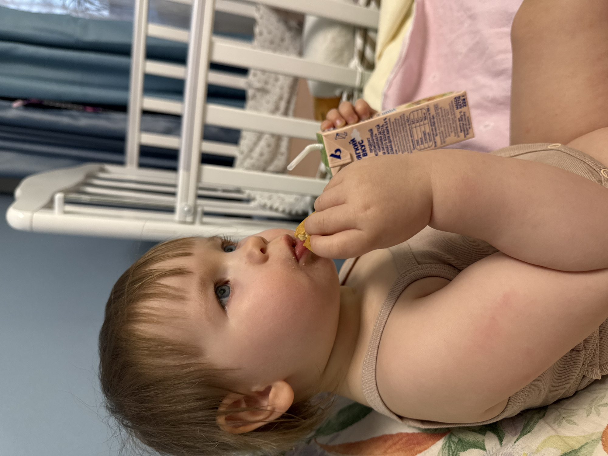 Toddler enjoys snack and juice in Moscow