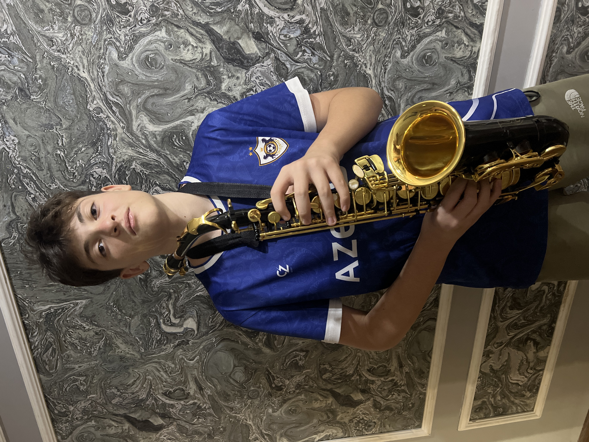 Saxophone and collectibles arranged in a Masazir interior