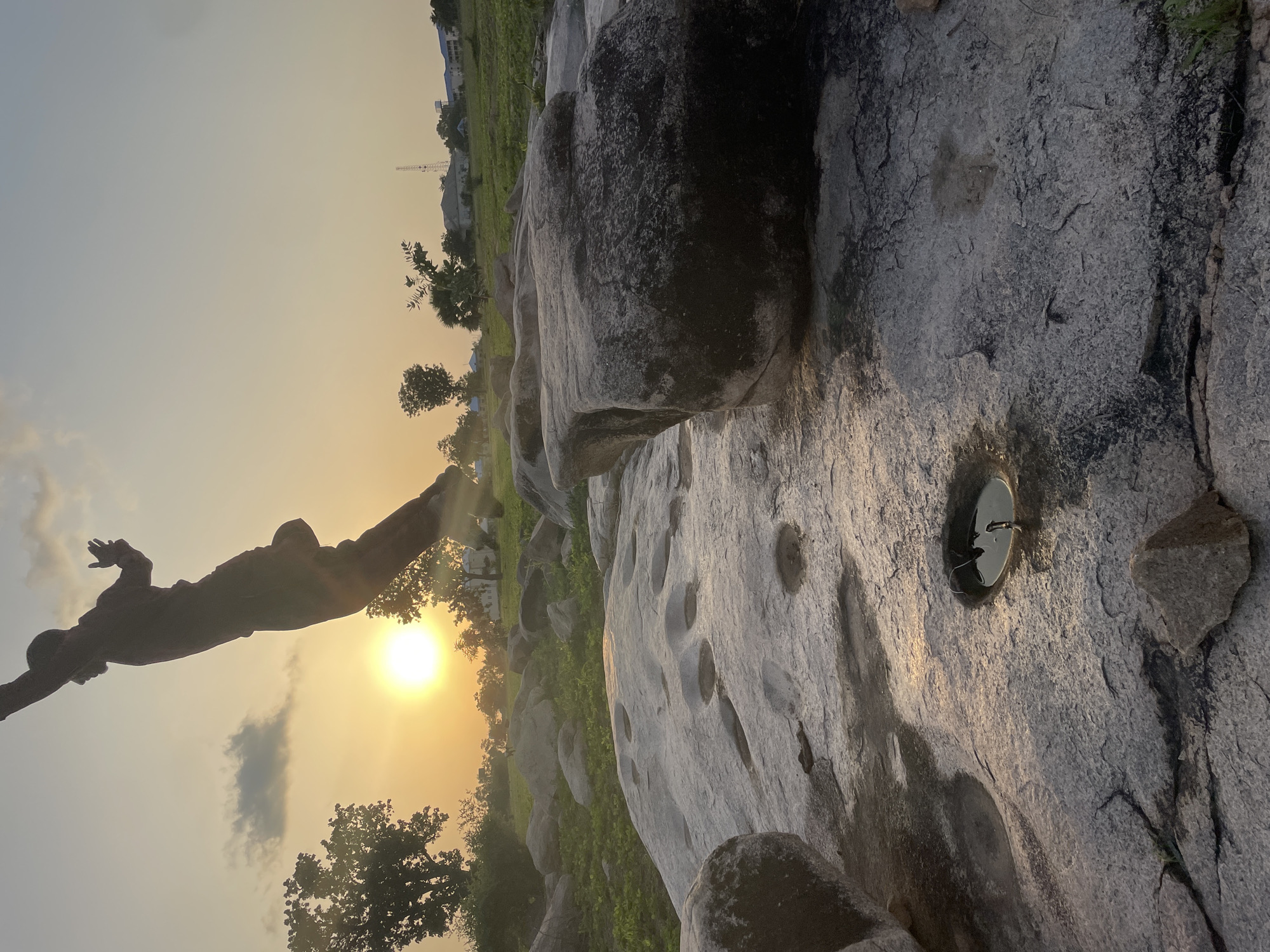 Jalingo street life at golden hour, with outdoor pool tables and rocky hangouts