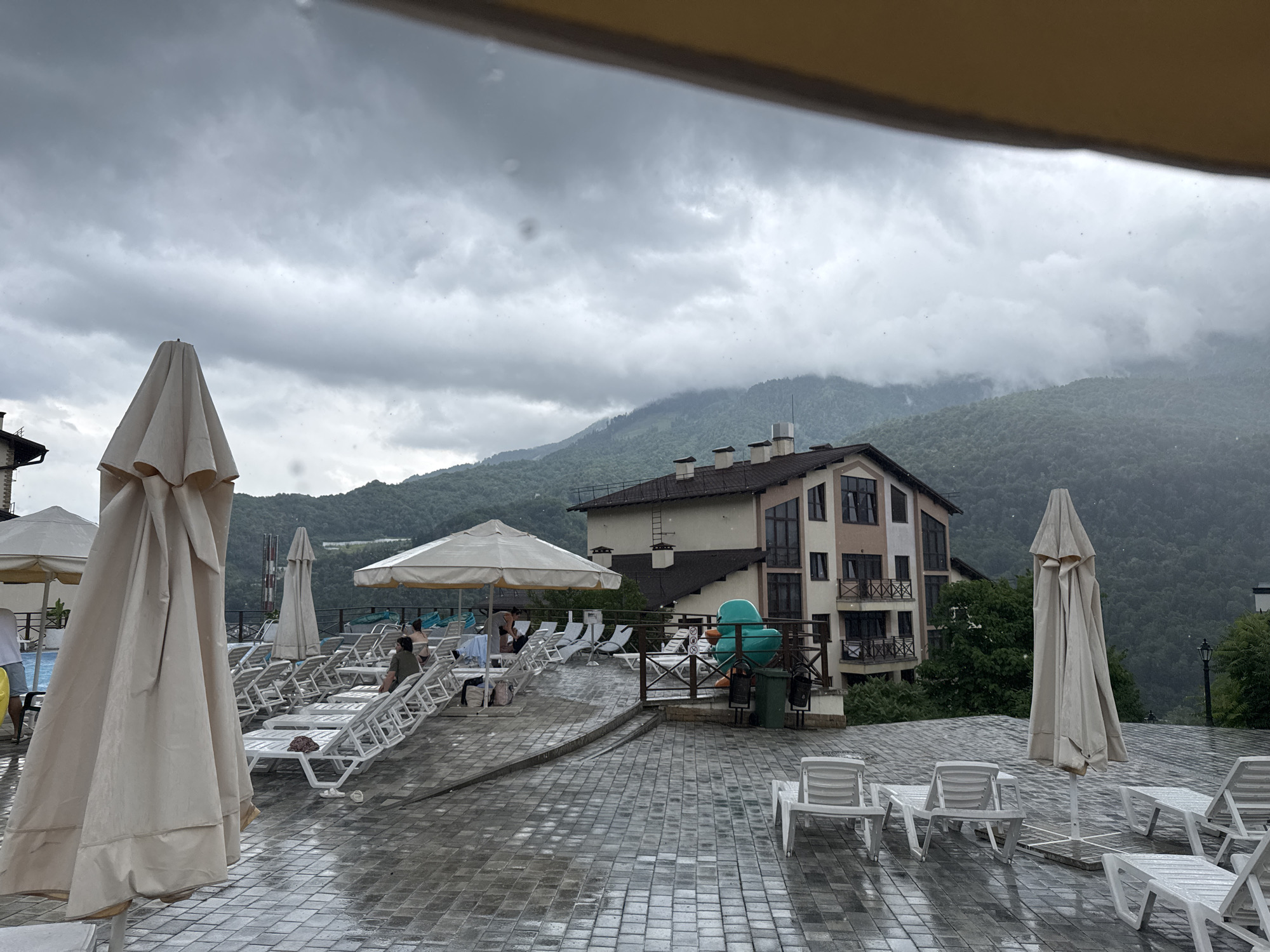 Rainy day at a Krasnaya Polyana mountain resort pool