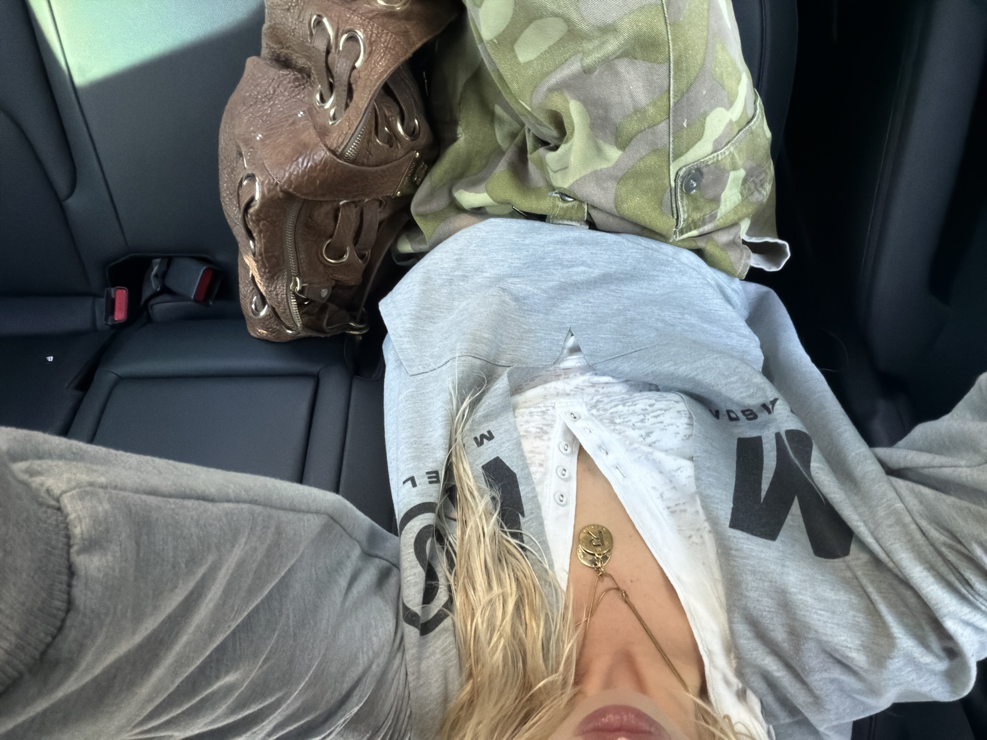 Person in grey sweatshirt observed in vehicle backseat, Seoul
