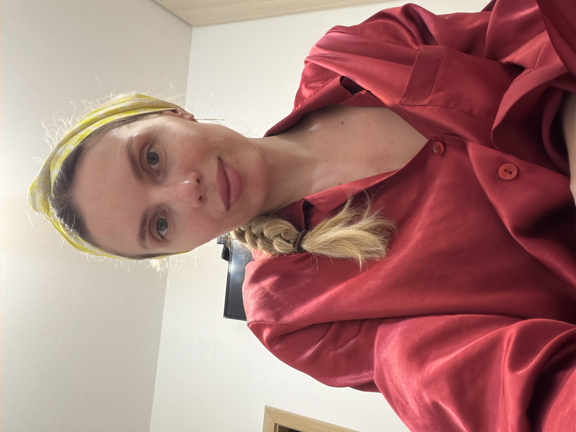 Woman applies skincare routine in Budva home evening