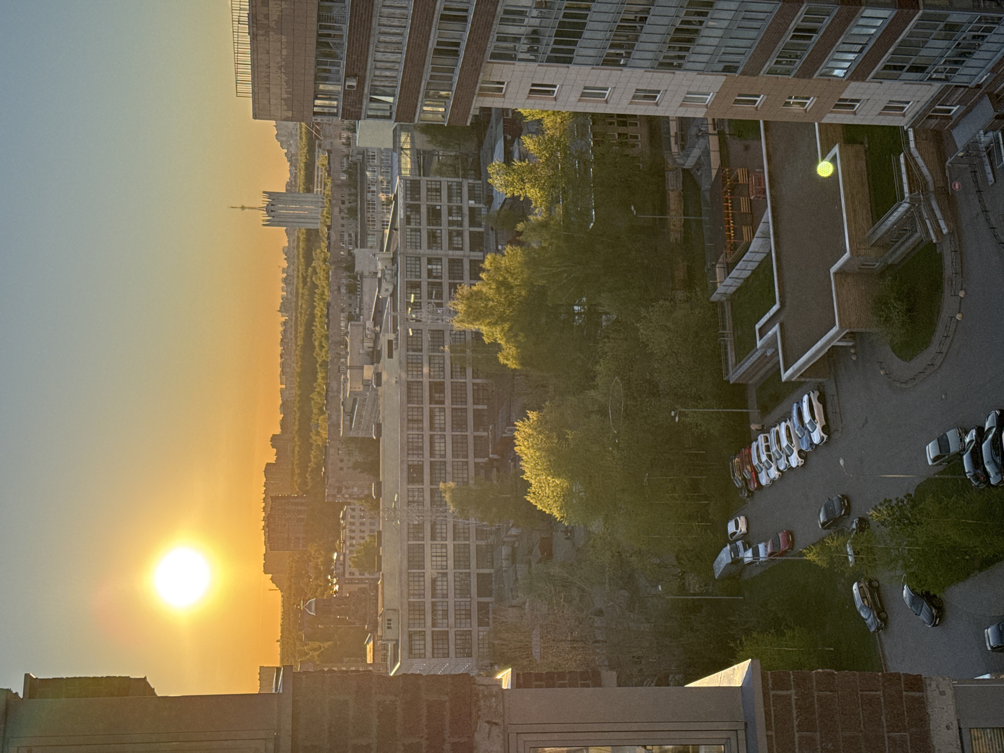 Urban sunset captured from elevated position showing varied cityscape