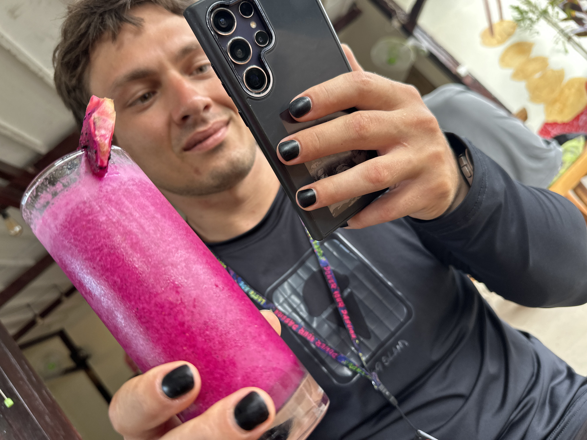 Person enjoys pink smoothie with dragon fruit in Indonesia