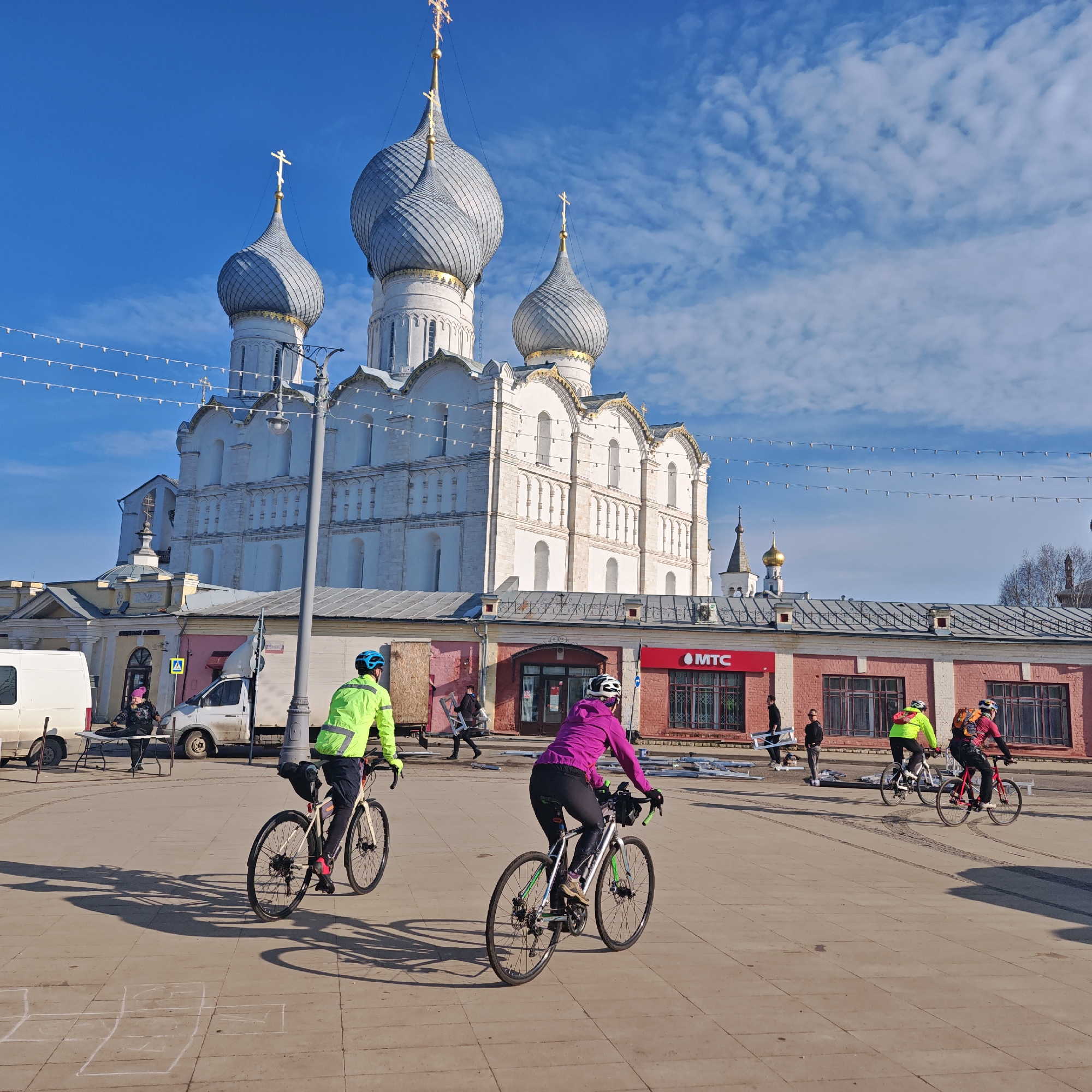 Tourists document sunny day at historic Rostov Kremlin complex