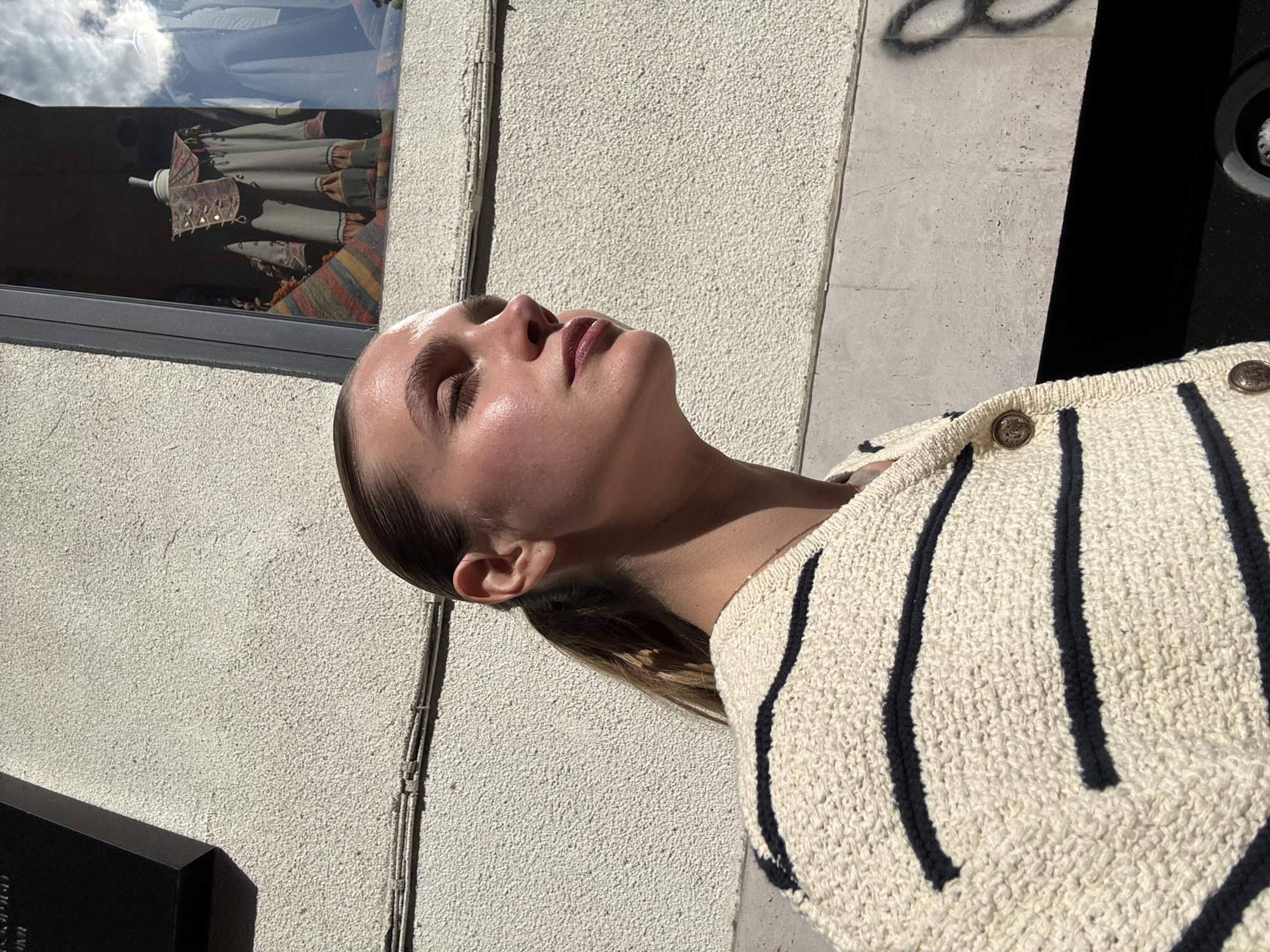 Woman enjoys sunny moment outdoors in Tbilisi