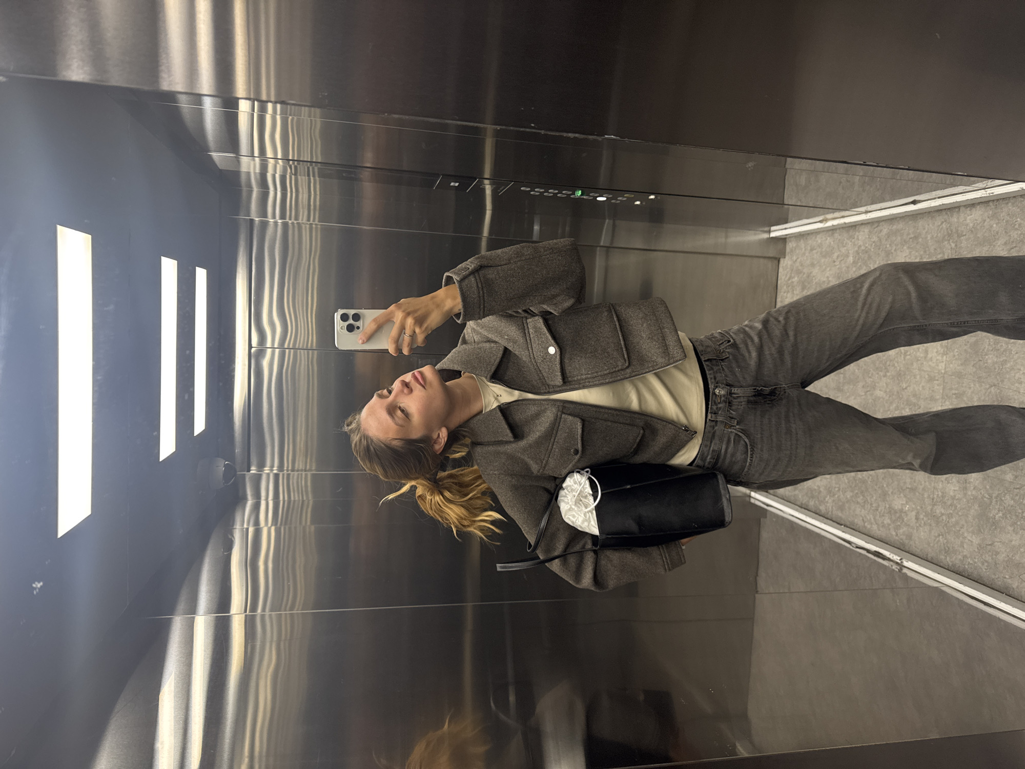 Person Takes Selfie in Stainless Steel Elevator