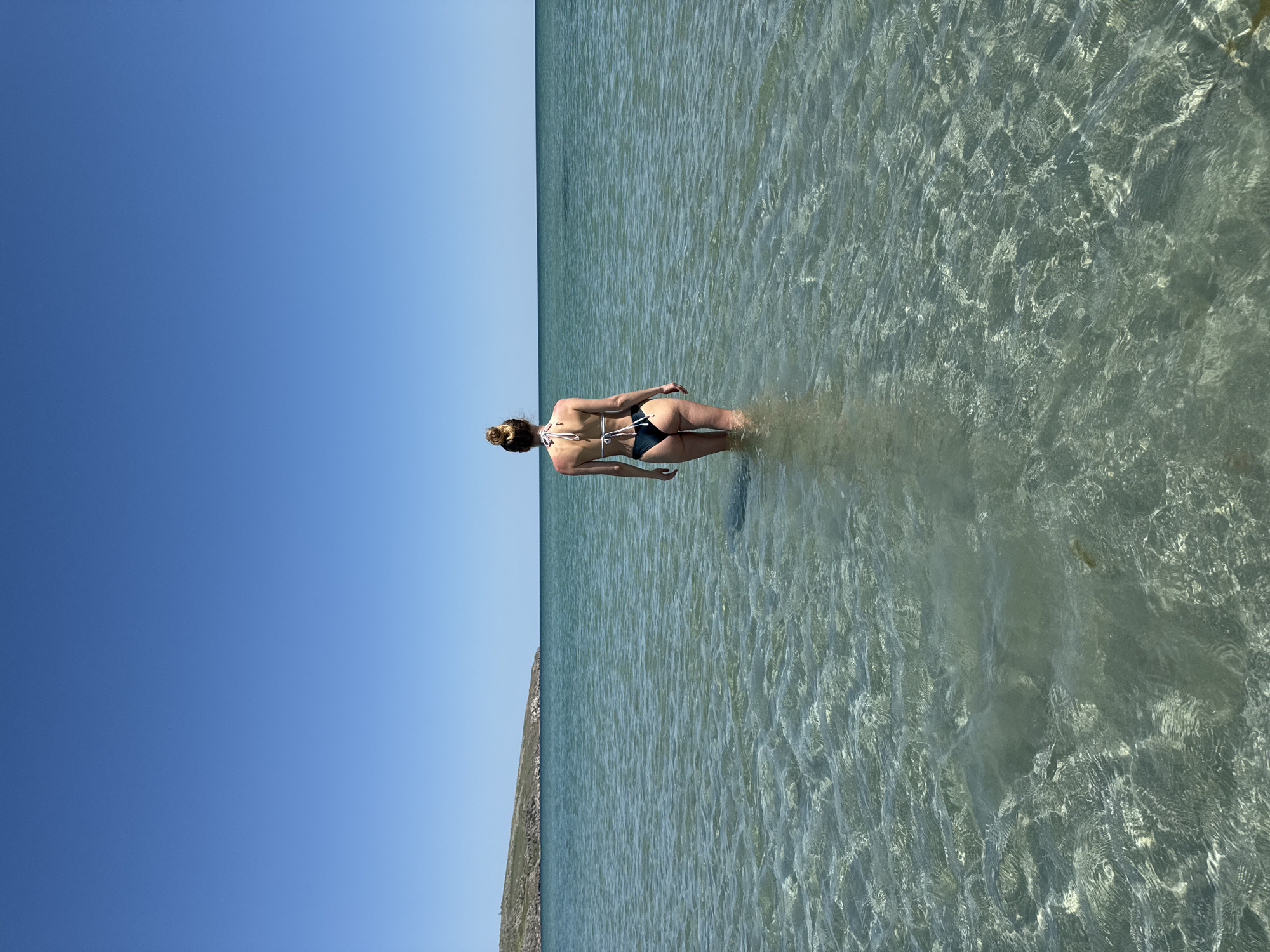 Woman stands in shallow water in Ukrainian village