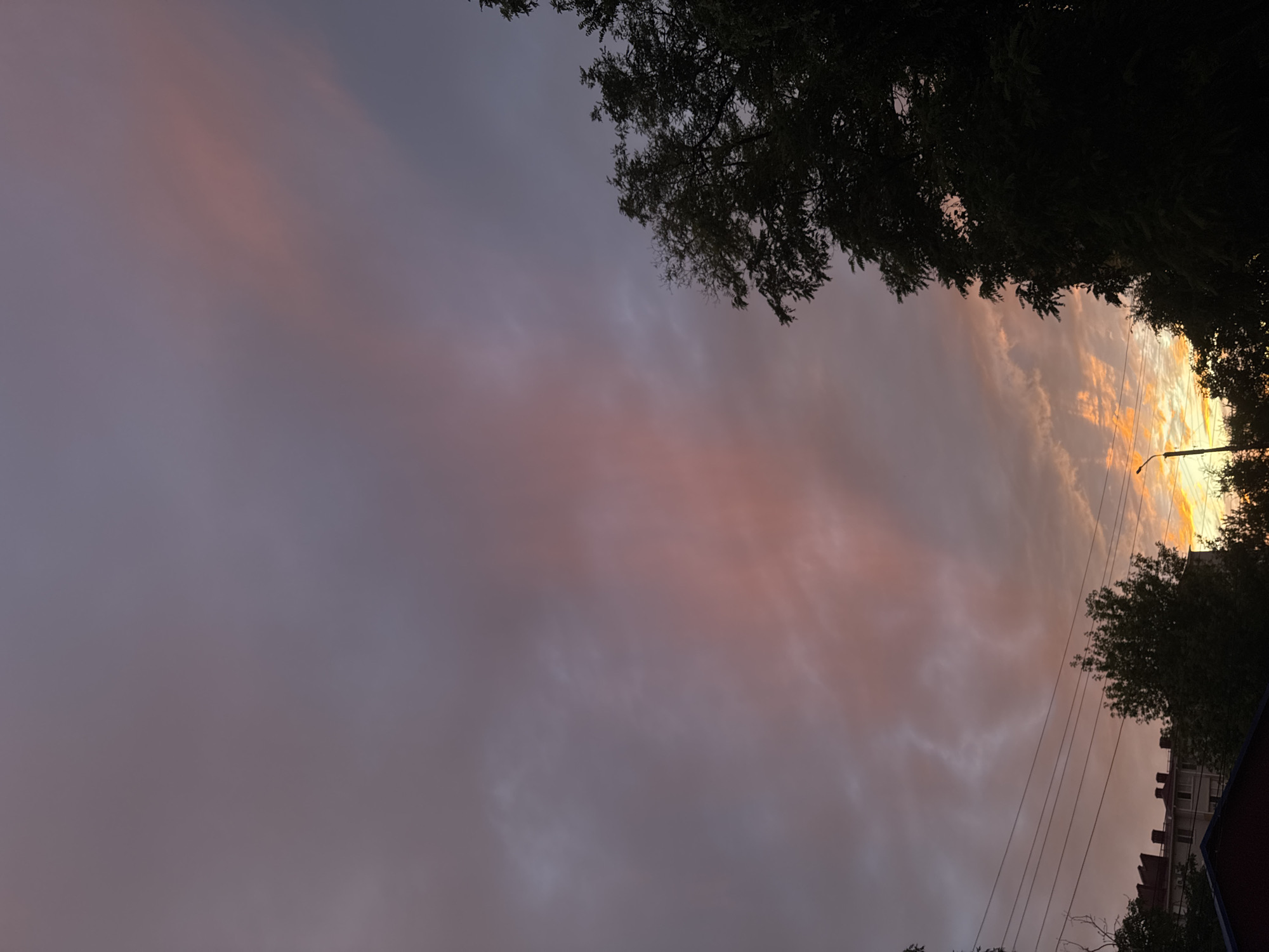 Rainbow over a Southeast Asian city at dusk after rain