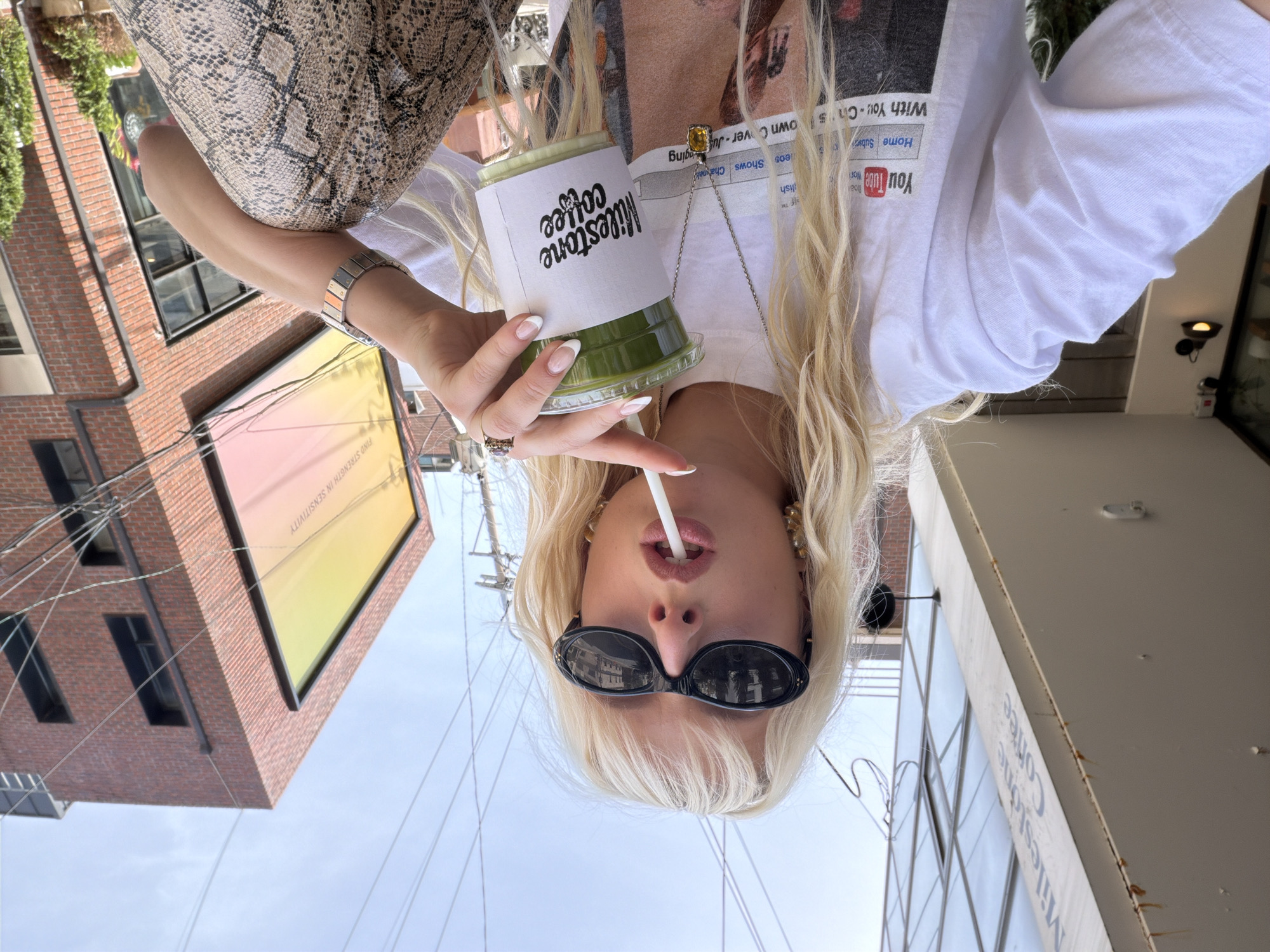 Woman enjoys coffee at outdoor Seoul cafe early morning