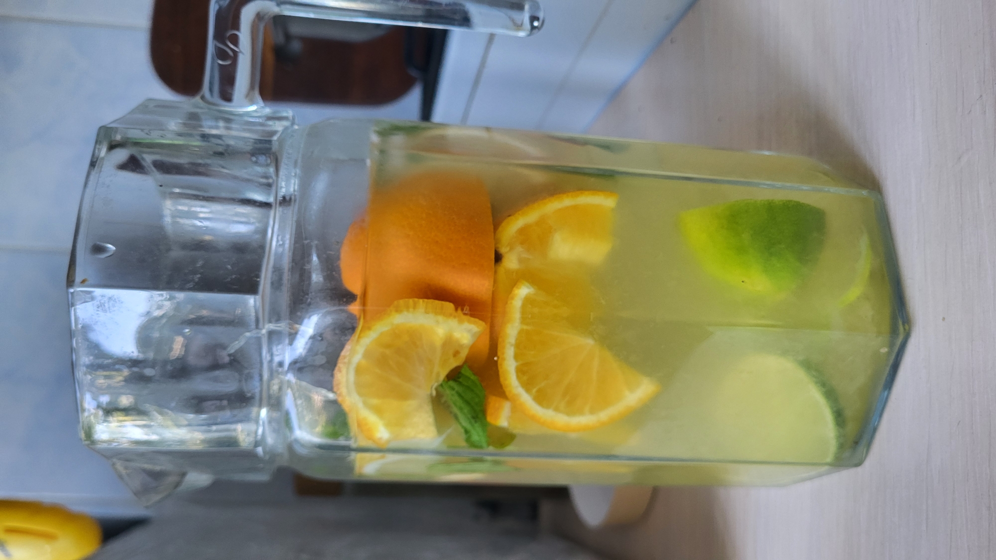 Citrus-infused drinks and fresh oranges on a tabletop