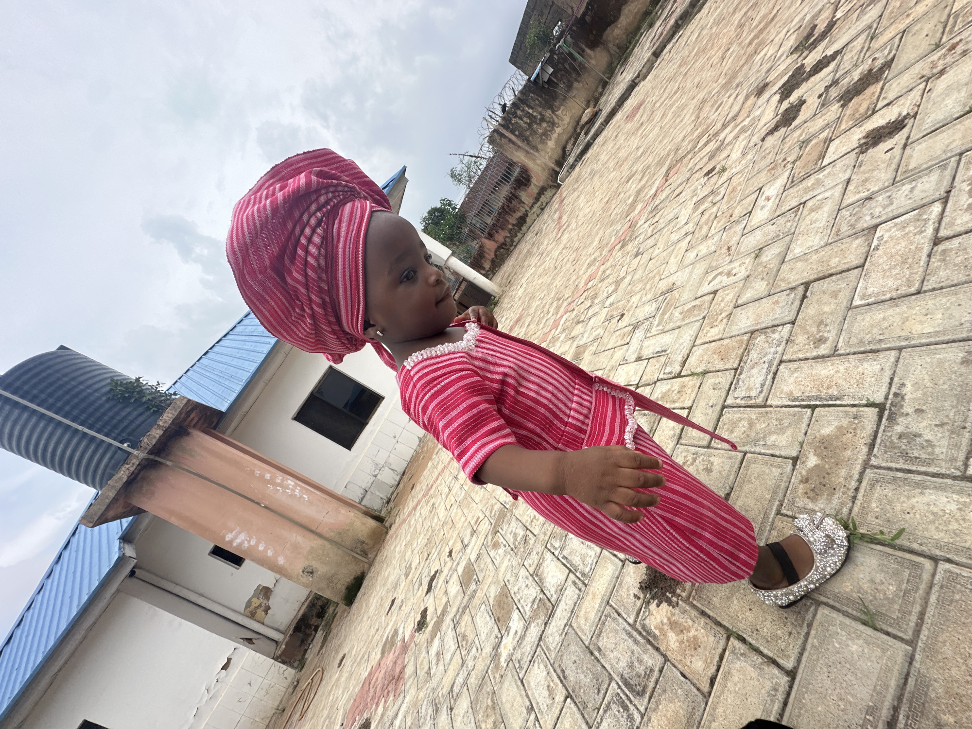 Jos street life features young girl in traditional dress