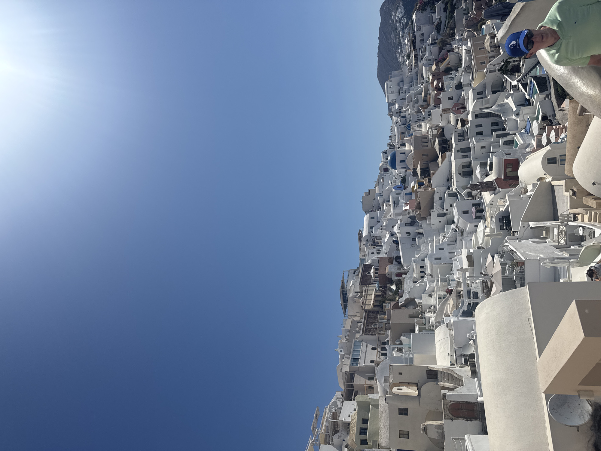Oia's whitewashed cliffs and blue domes on a sunny morning